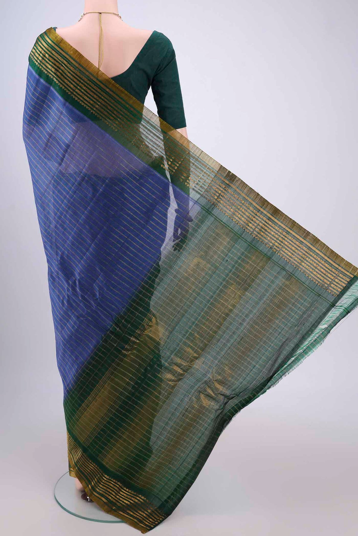 Flat view of Blue Gadwal Silk Saree with Stripes on the body and Zari Border. 
