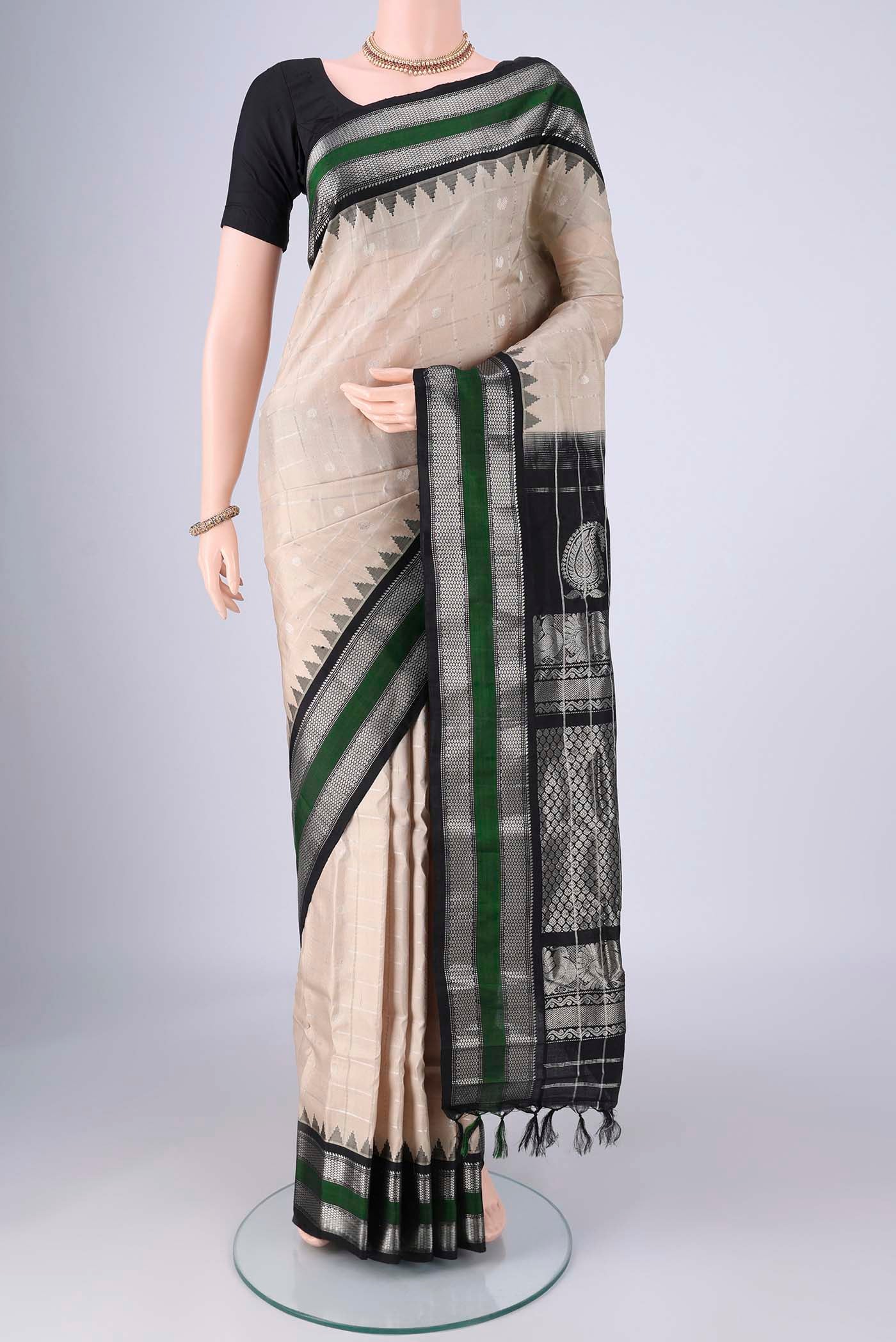 Beige Gadwal Silk Saree with Checked design on the body and Zari Border.  displayed on a mannequin