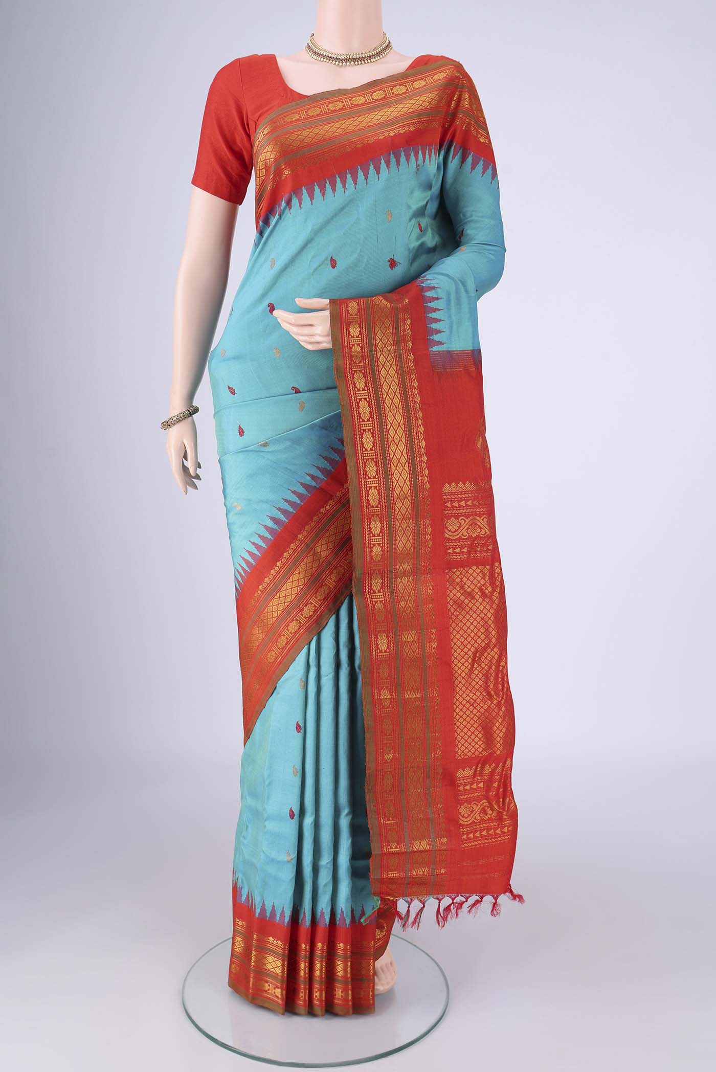 Turquoise Gadwal Silk Saree with Zari Butta on the body and Zari Border.  displayed on a mannequin