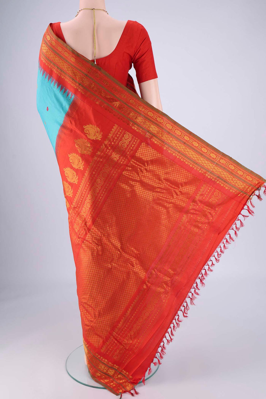 Flat view of Turquoise Gadwal Silk Saree with Zari Butta on the body and Zari Border. 