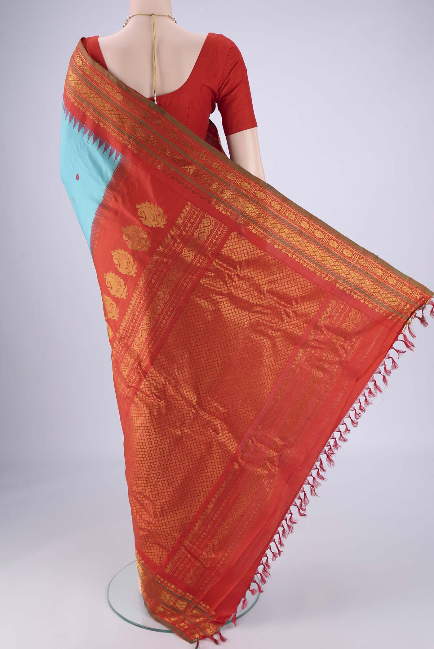 Flat view of Turquoise Gadwal Silk Saree with Zari Butta on the body and Zari Border. 