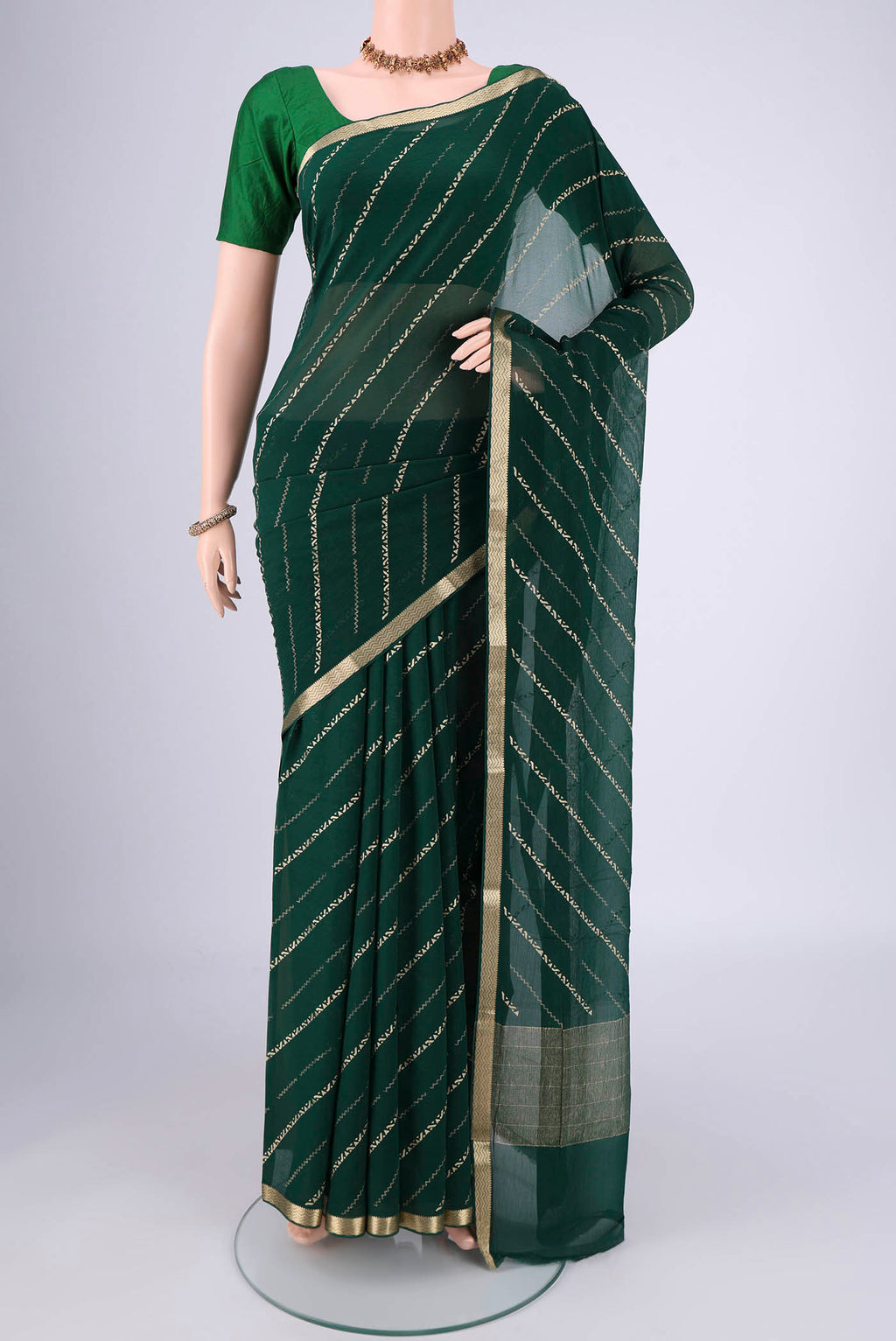 Bottle Green Mysore Chiffon Saree with Stripes on the body and Zari Border.  displayed on a mannequin