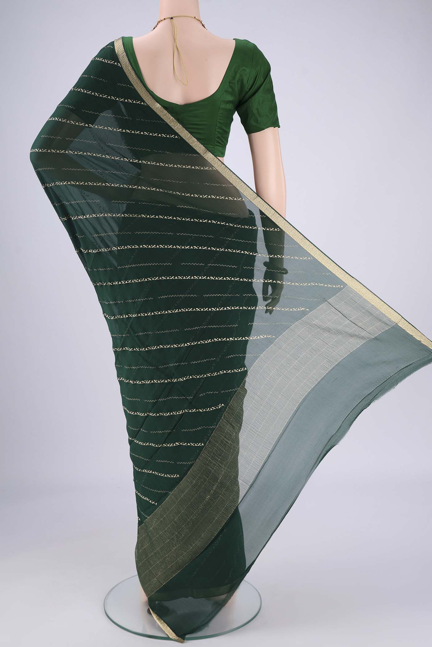 Flat view of Bottle Green Mysore Chiffon Saree with Stripes on the body and Zari Border. 