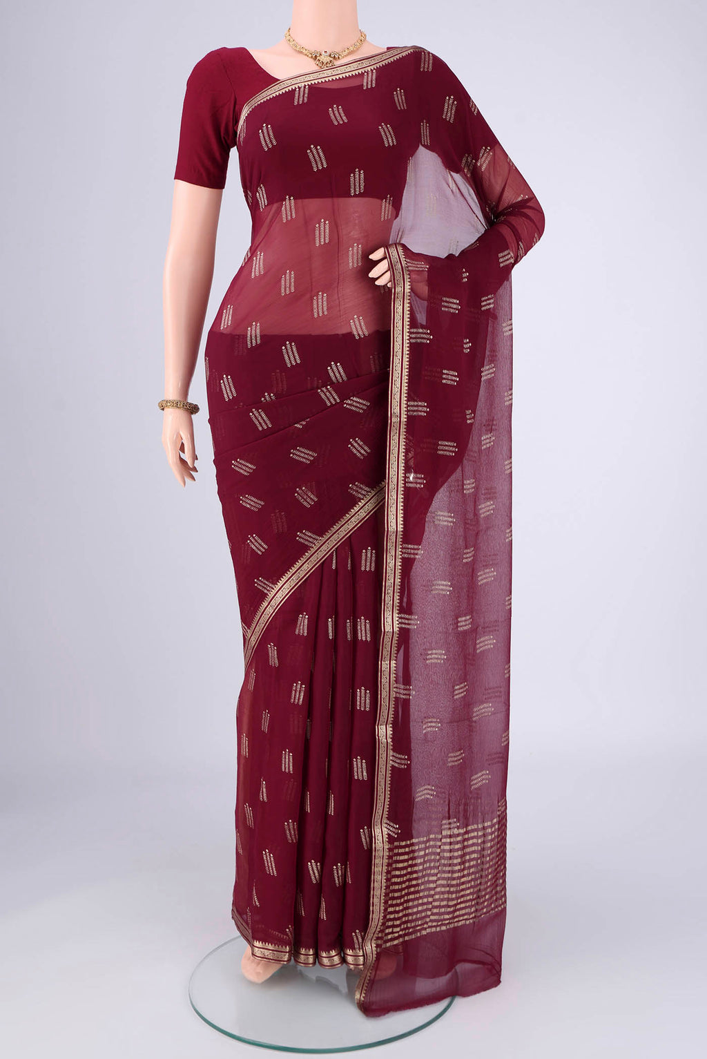 Burgundy Mysore Chiffon Saree with Zari Butta on the body and Zari Border.  displayed on a mannequin