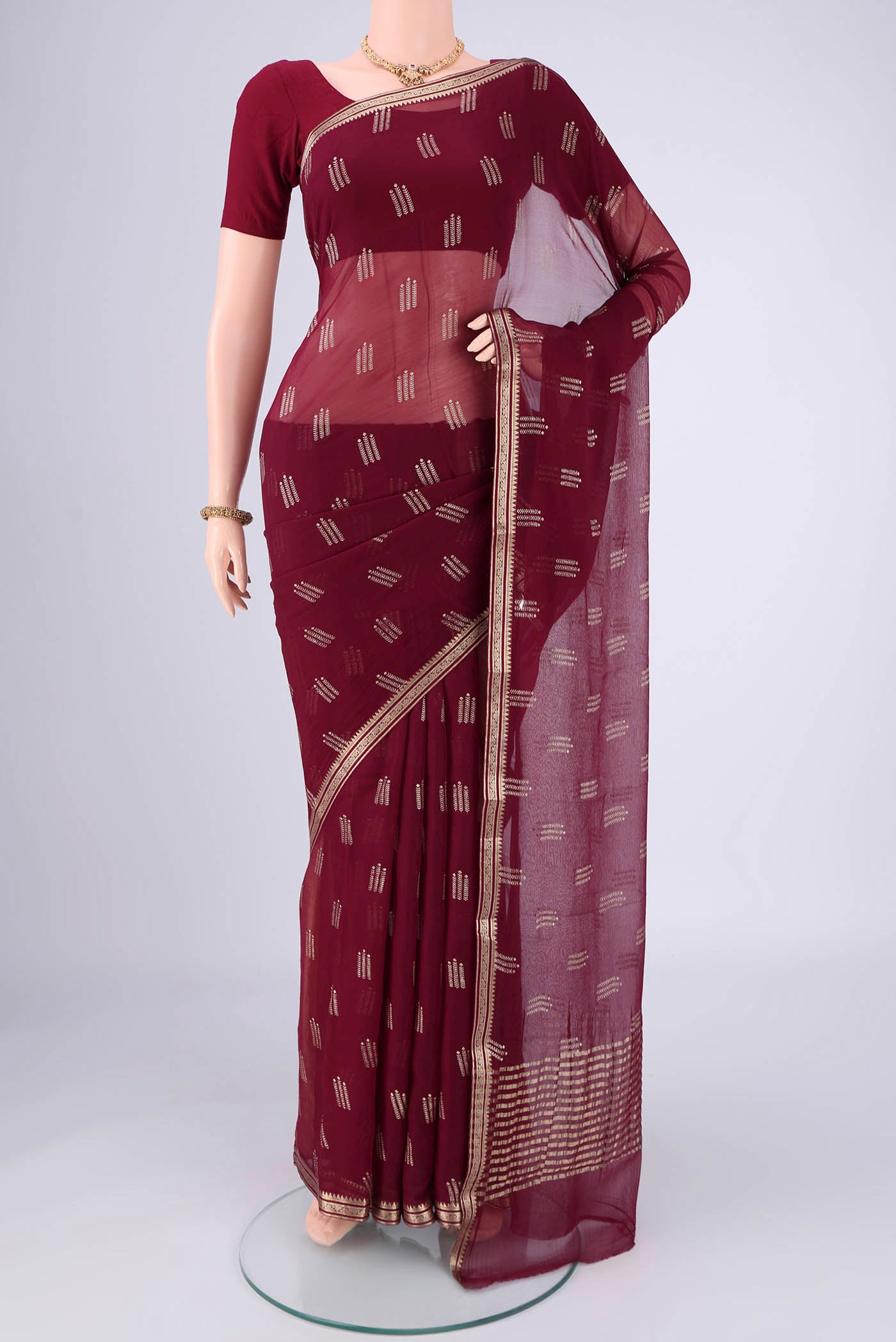 Burgundy Mysore Chiffon Saree with Zari Butta on the body and Zari Border.  displayed on a mannequin