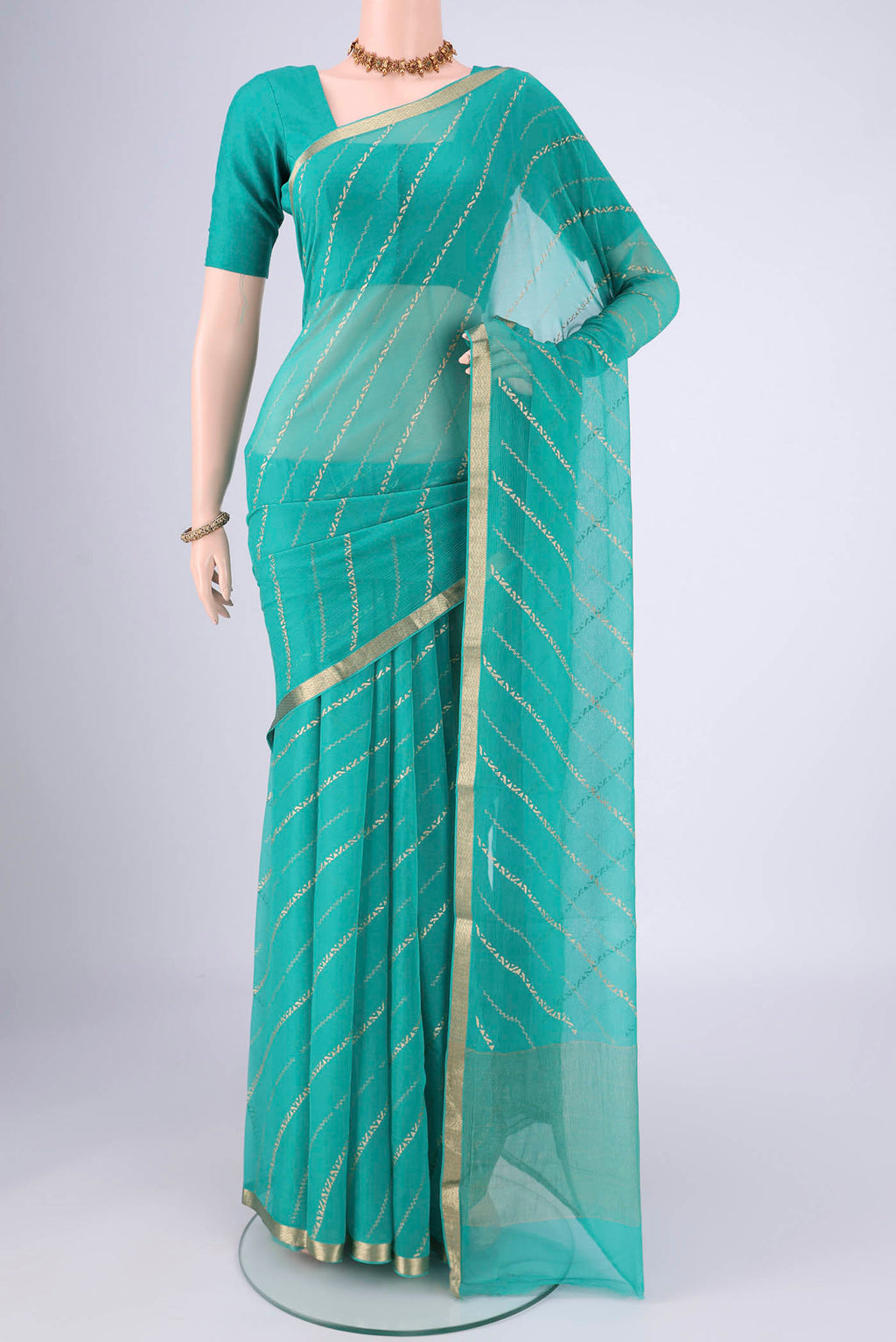 Turquoise Mysore Chiffon Saree with Stripes on the body and Zari Border.  displayed on a mannequin