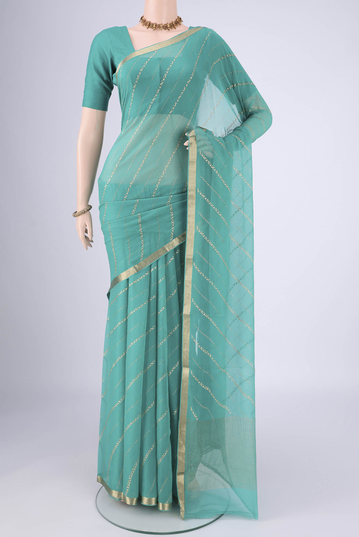 Turquoise Mysore Chiffon Saree with Stripes on the body and Zari Border.  displayed on a mannequin