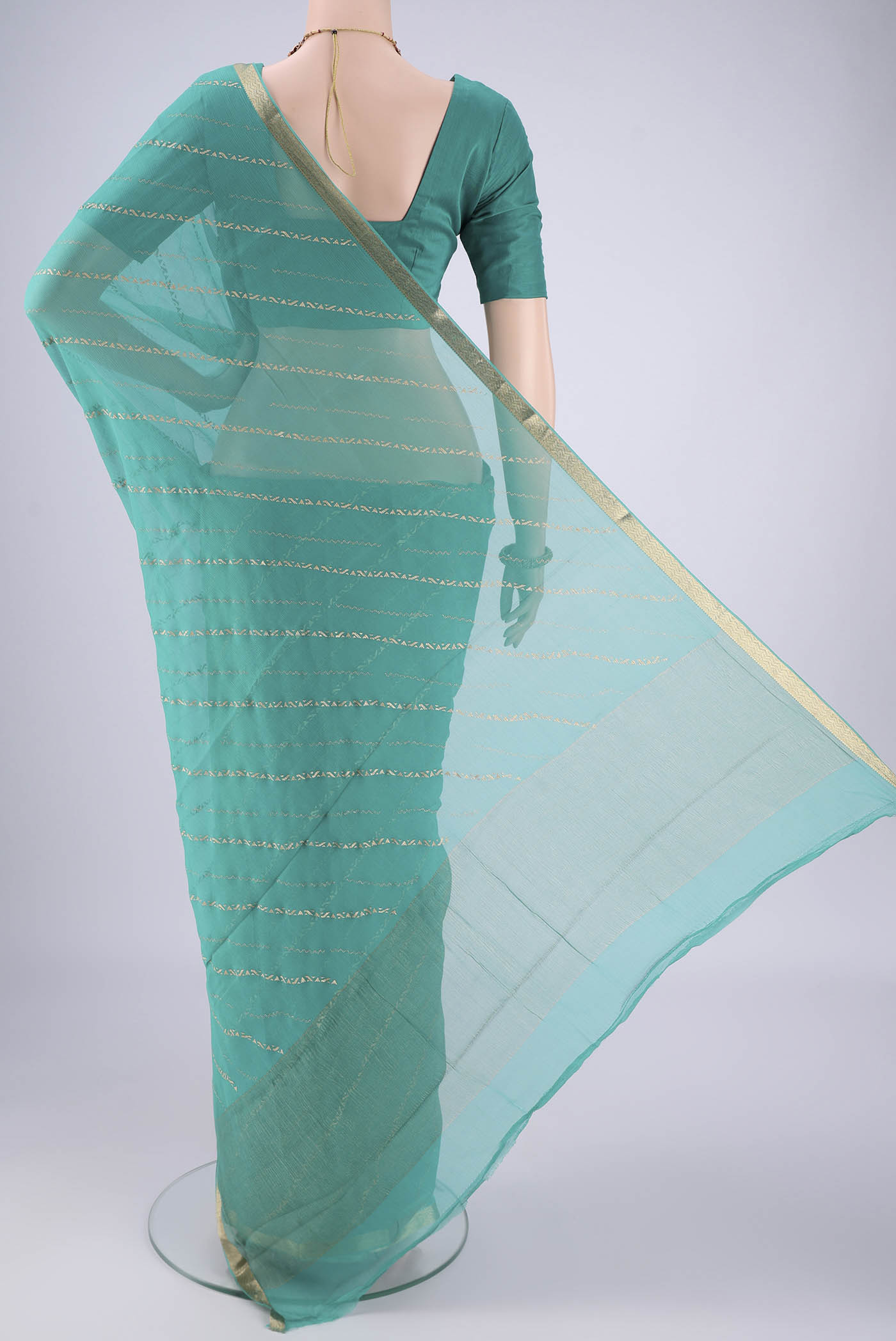 Flat view of Turquoise Mysore Chiffon Saree with Stripes on the body and Zari Border. 