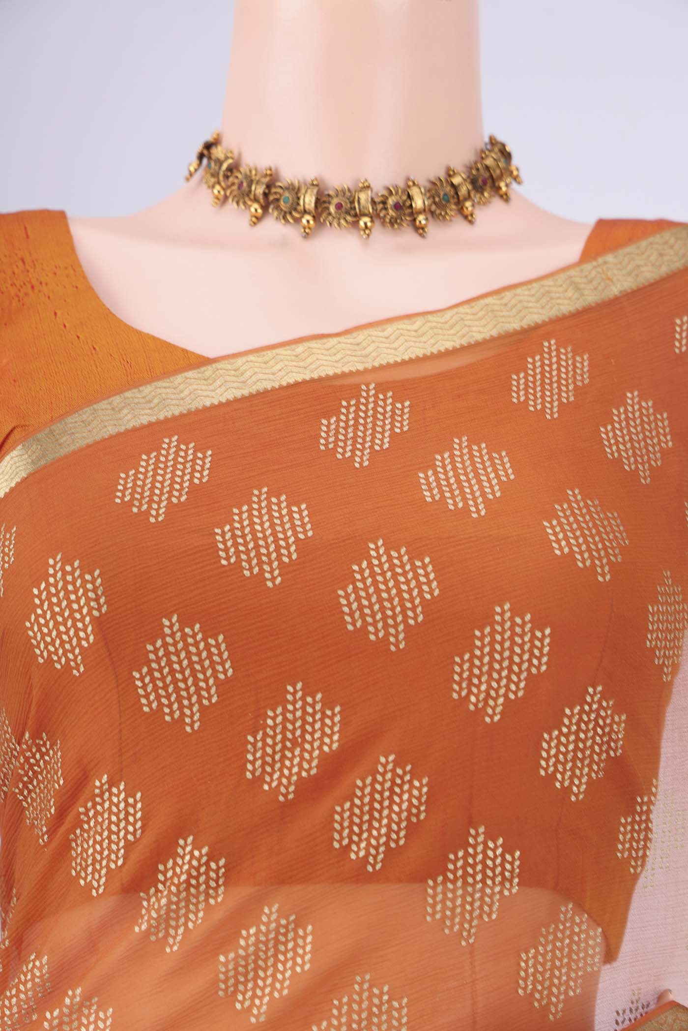 Border image of Brick Orange Mysore Chiffon Saree with Zari Butta on the body and Zari Border. 