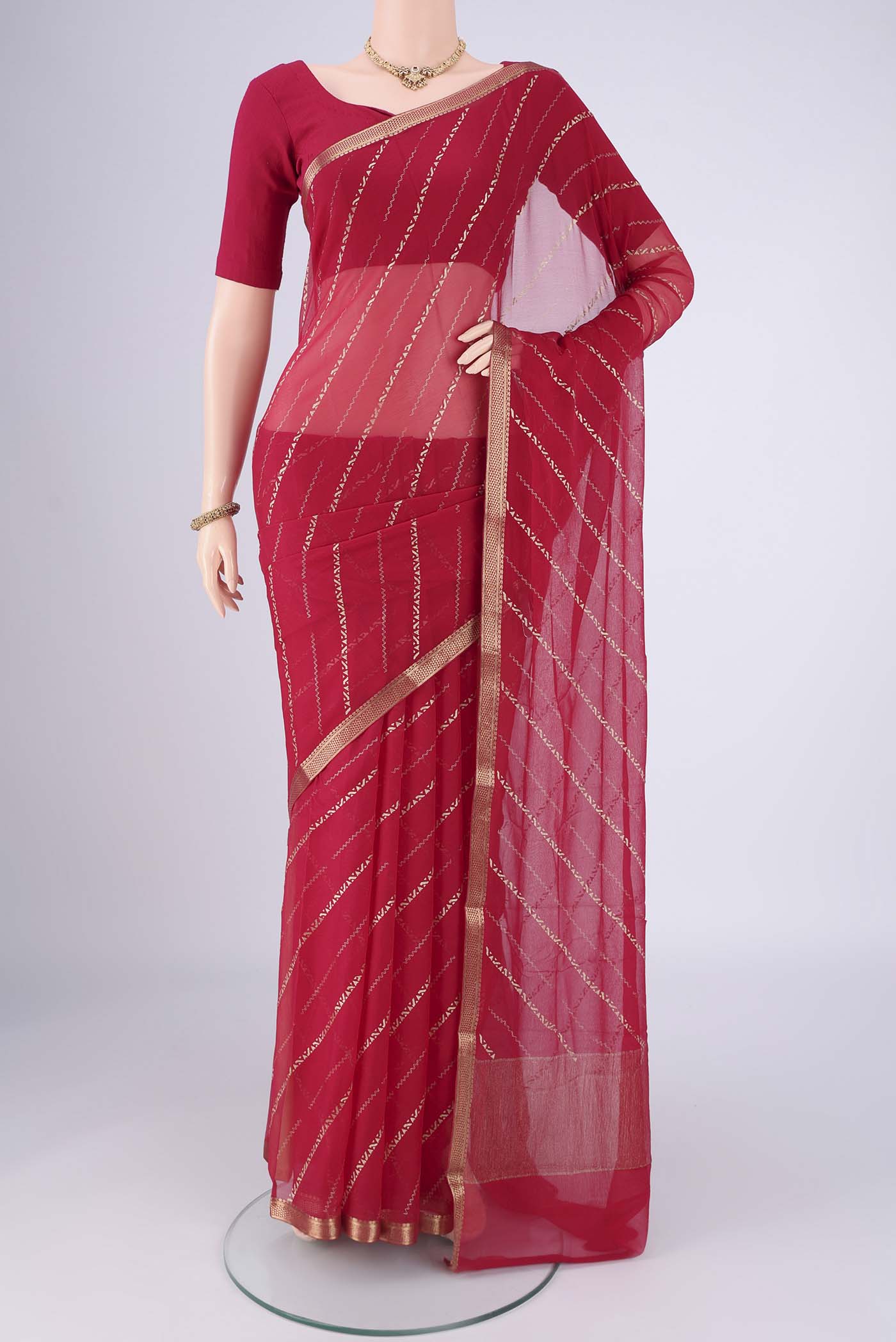 Dark Pink Mysore Chiffon Saree with Stripes on the body and Zari Border.  displayed on a mannequin