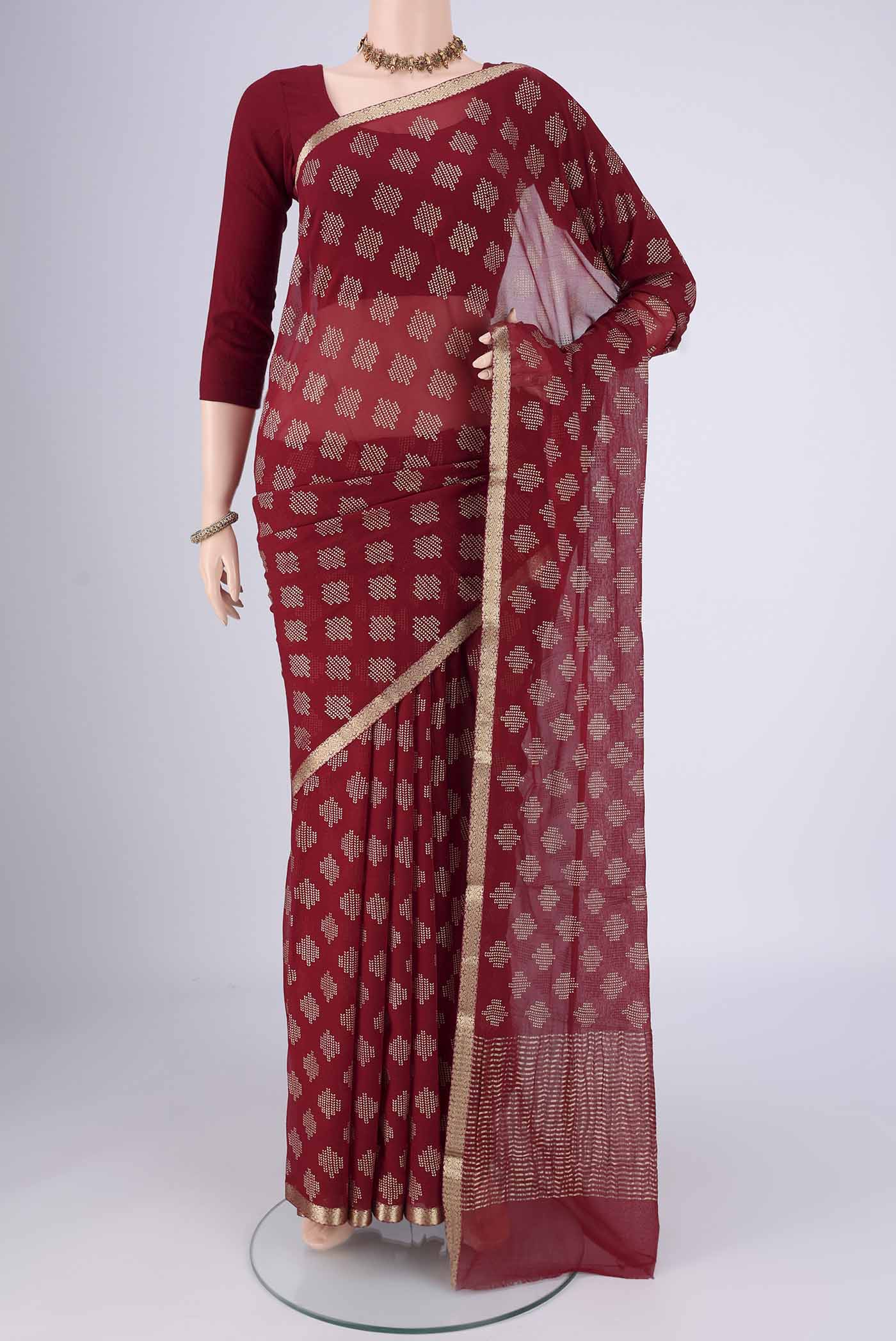Maroon Mysore Chiffon Saree with Zari Butta on the body and Zari Border.  displayed on a mannequin