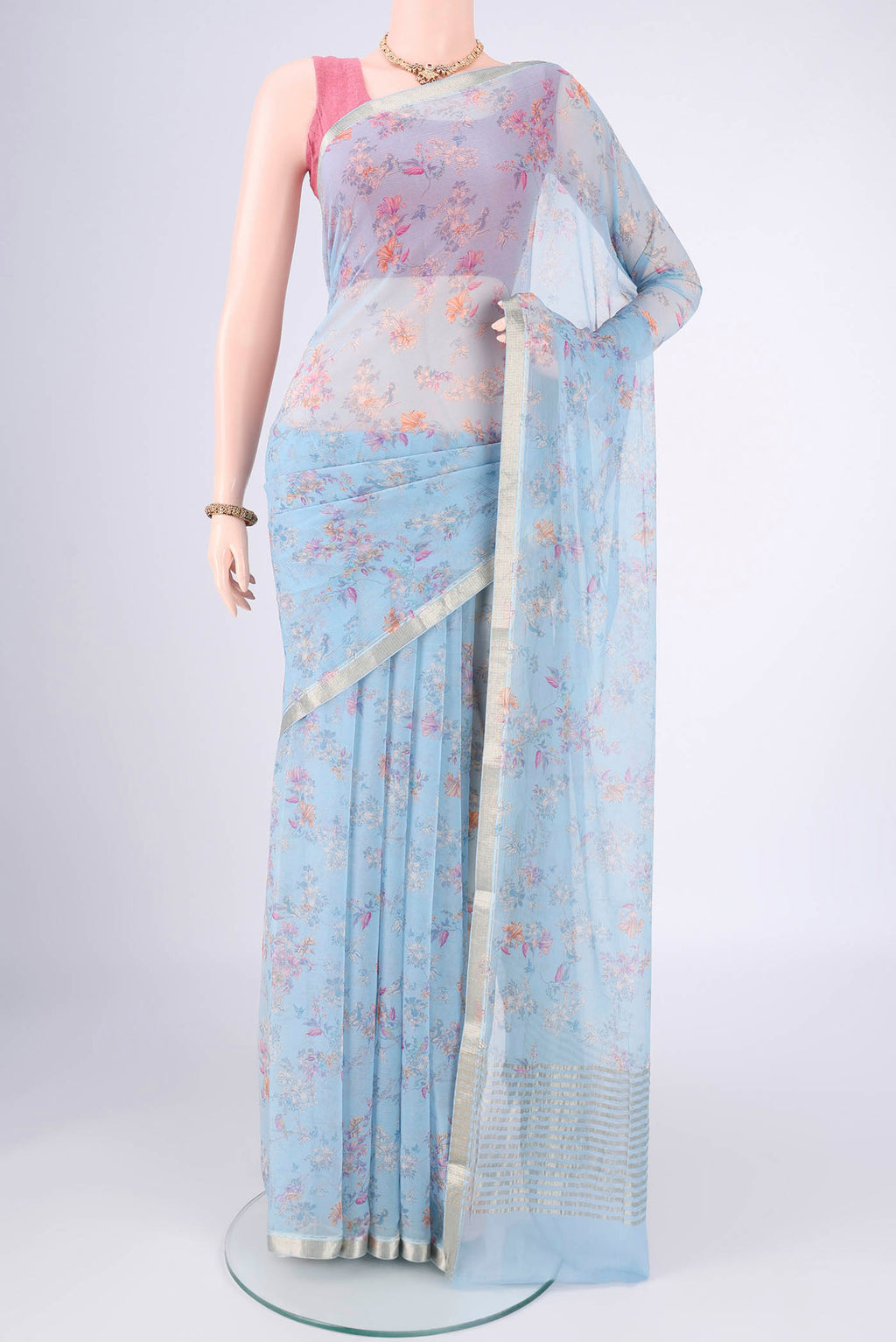 Sky Blue Mysore Crepe Saree with Printed design on the body and Zari Border.  displayed on a mannequin