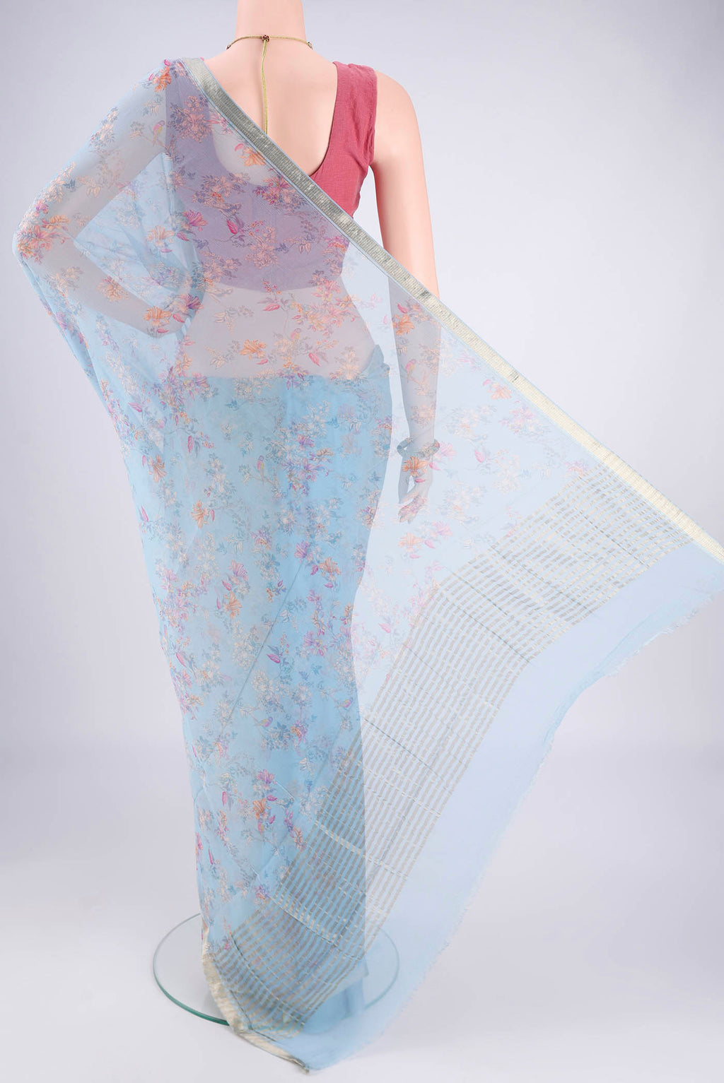 Flat view of Sky Blue Mysore Crepe Saree with Printed design on the body and Zari Border. 