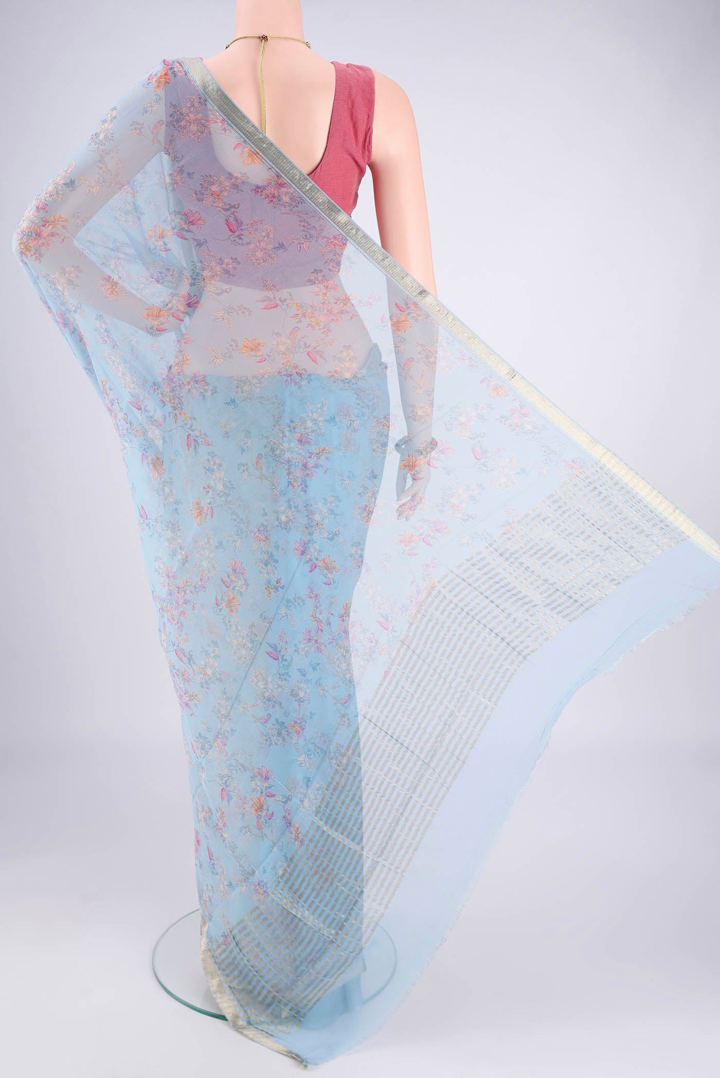 Flat view of Sky Blue Mysore Crepe Saree with Printed design on the body and Zari Border. 