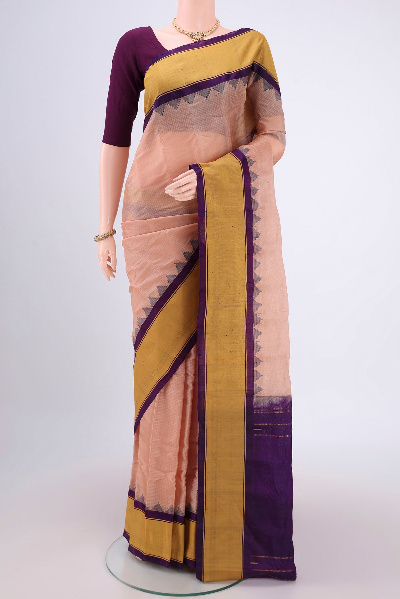 Peach Gadwal Silk Saree with Stripes on the body and Zari Border.  displayed on a mannequin
