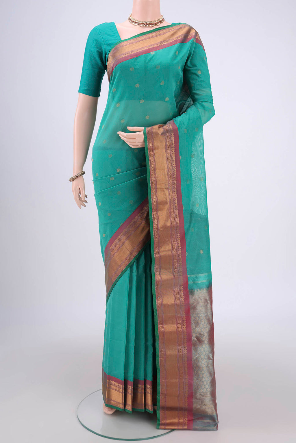 Sea Green Gadwal Silk Saree with Zari Butta on the body and Zari Border.  displayed on a mannequin