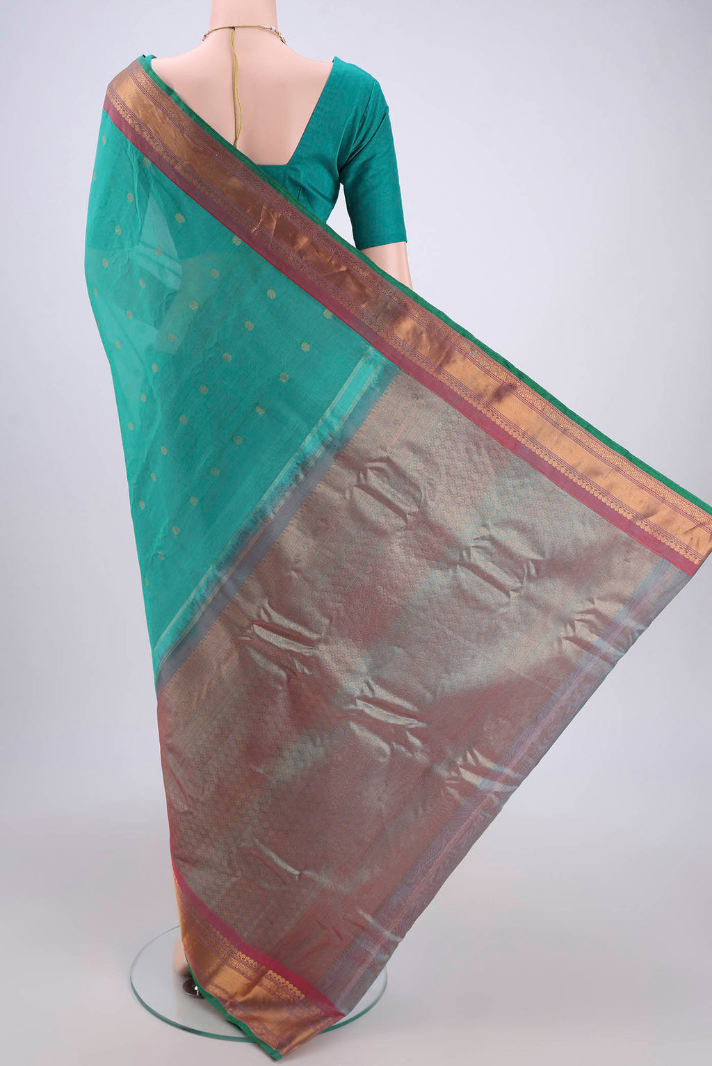 Flat view of Sea Green Gadwal Silk Saree with Zari Butta on the body and Zari Border. 