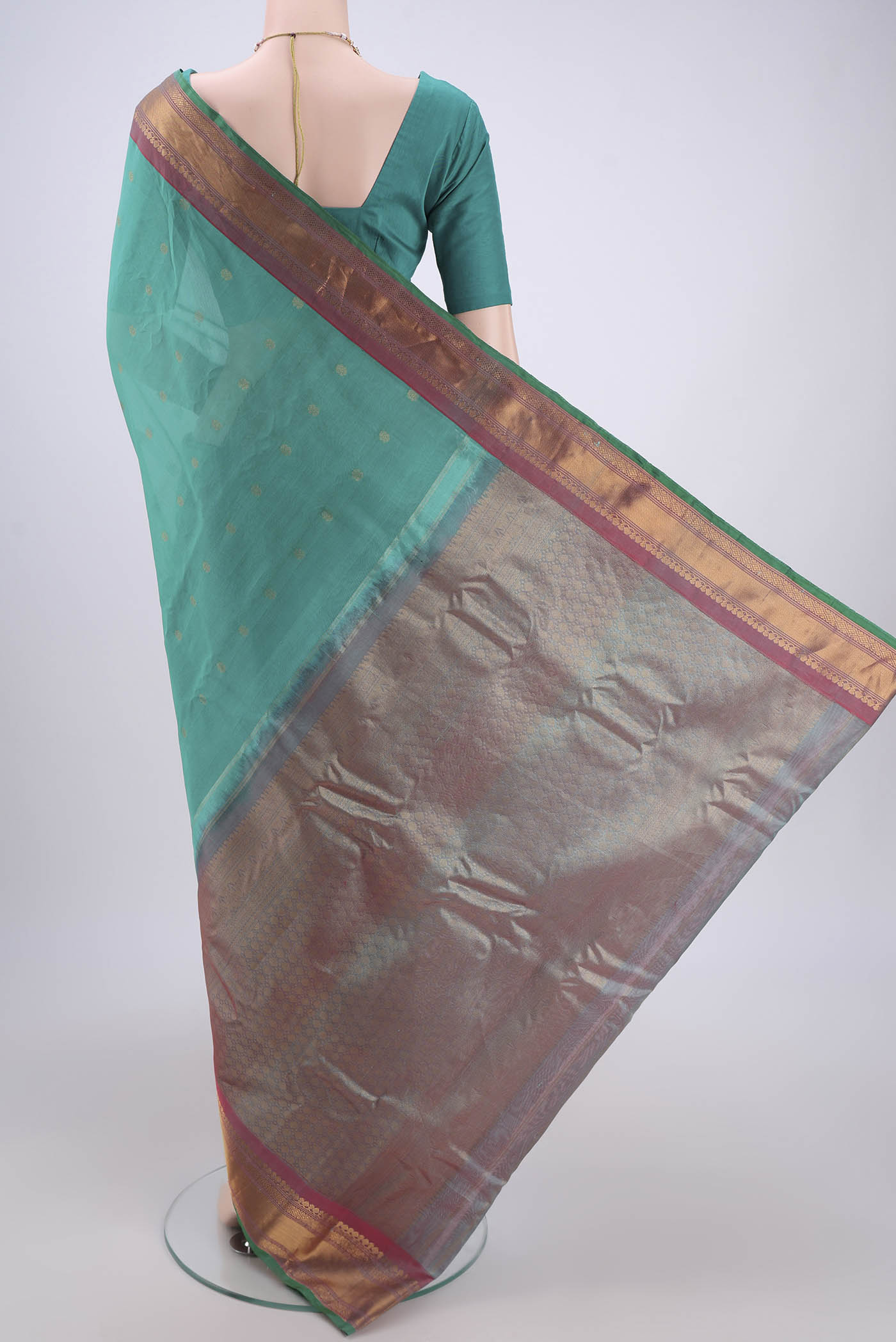 Flat view of Sea Green Gadwal Silk Saree with Zari Butta on the body and Zari Border. 