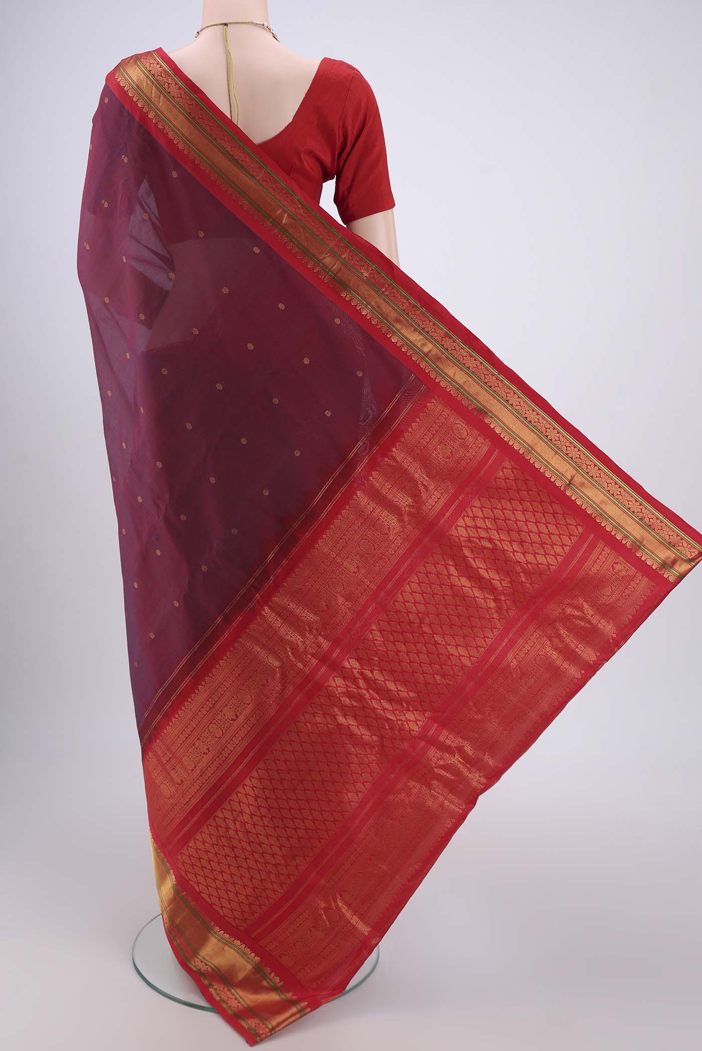 Flat view of Maroon Gadwal Silk Saree with Zari Butta on the body and Zari Border. 