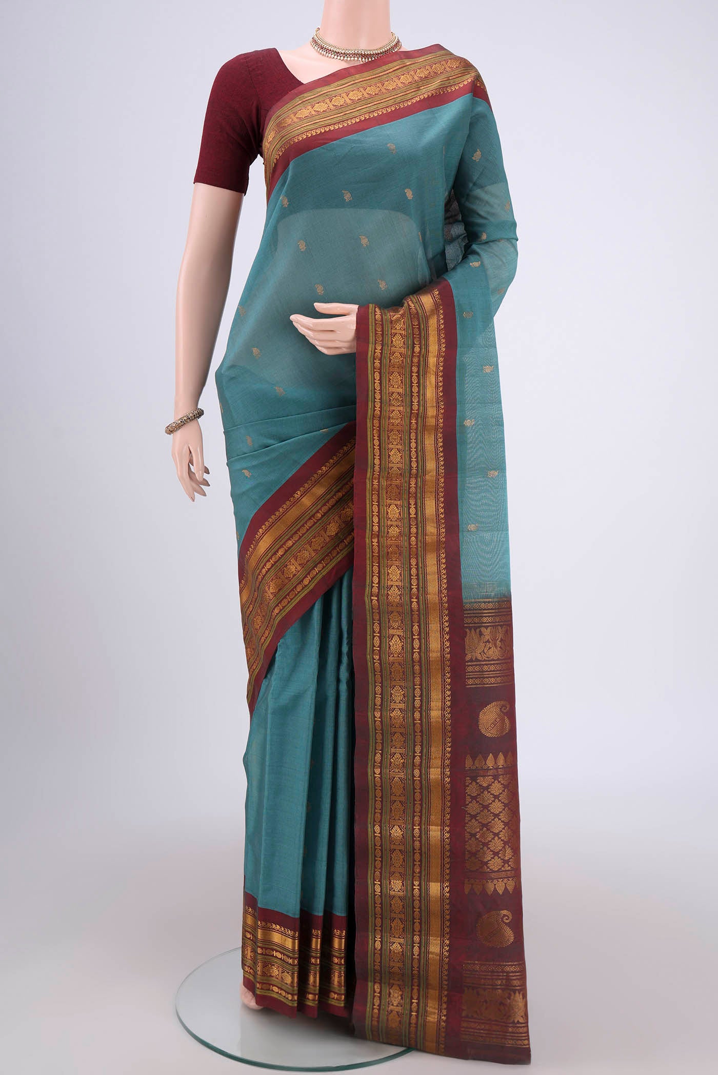 Maya Blue Gadwal Silk Saree with Zari Butta on the body and Zari Border.  displayed on a mannequin