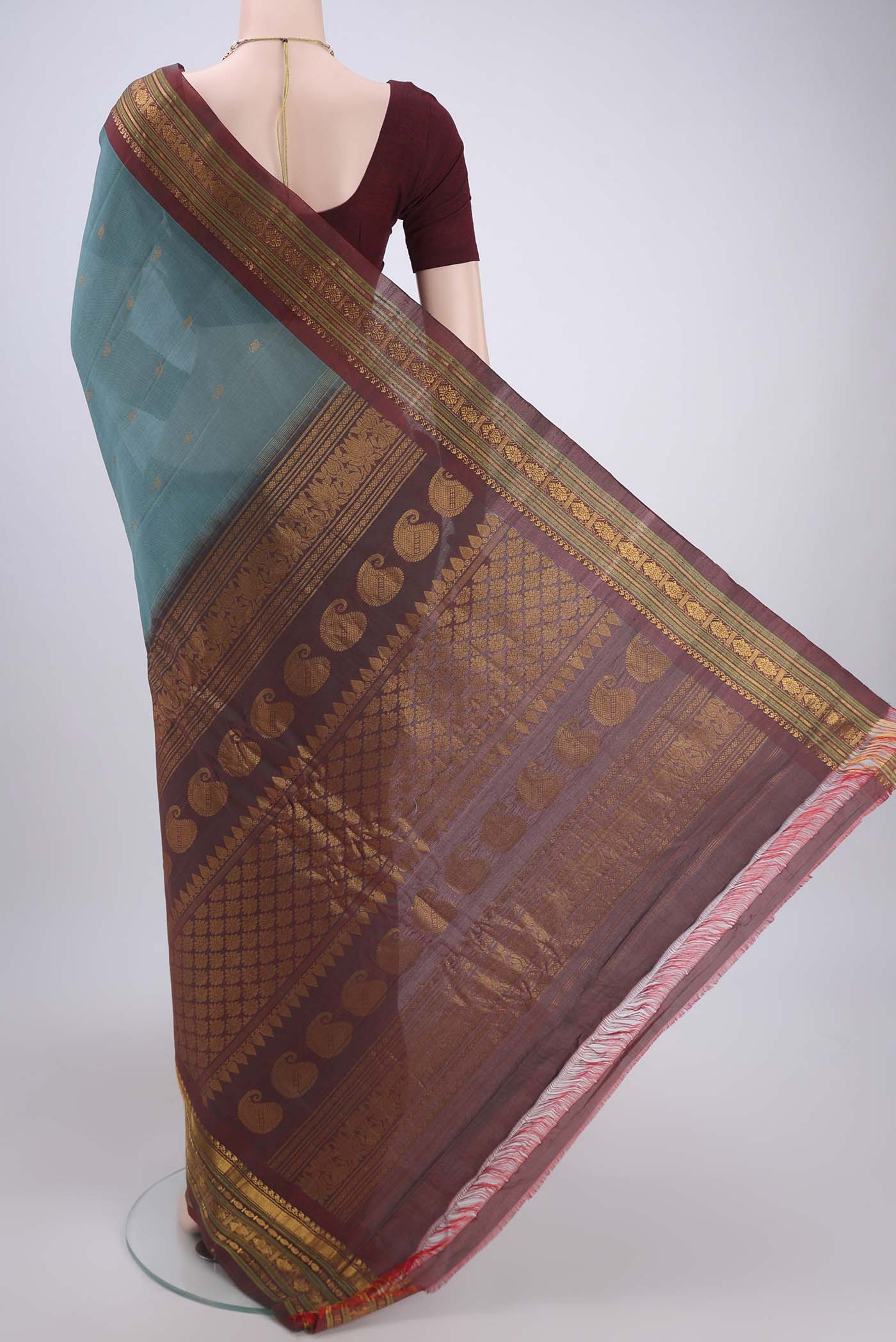 Flat view of Maya Blue Gadwal Silk Saree with Zari Butta on the body and Zari Border. 