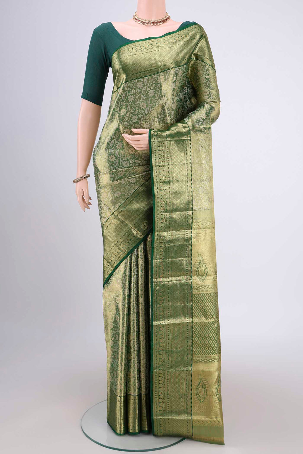 Bottle Green Kanjivaram Silk Saree with Zari Brocade on the body and Zari Border.  displayed on a mannequin