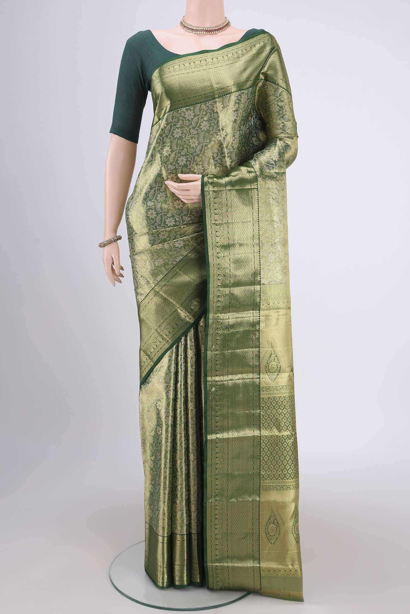 Bottle Green Kanjivaram Silk Saree with Zari Brocade on the body and Zari Border.  displayed on a mannequin