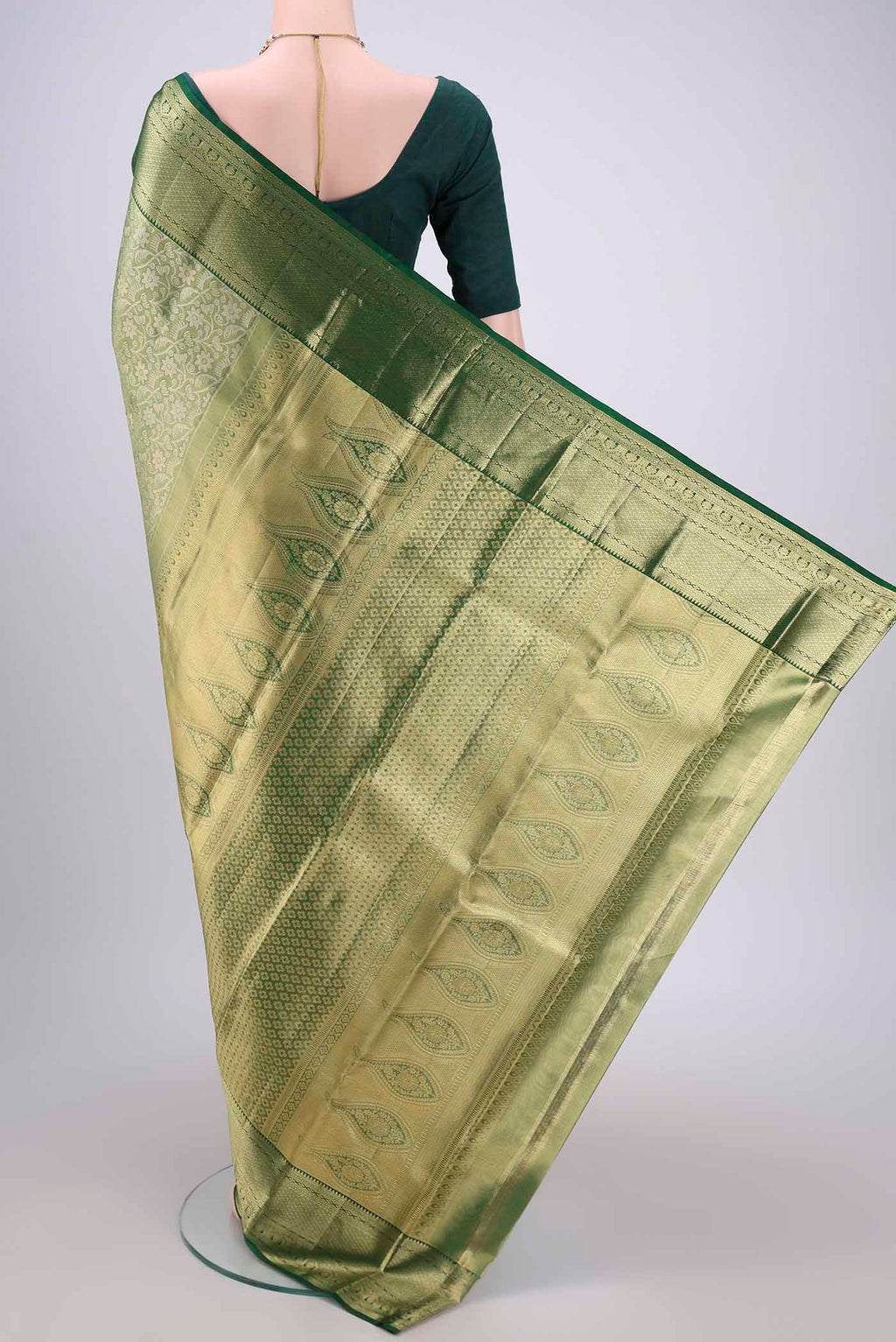 Flat view of Bottle Green Kanjivaram Silk Saree with Zari Brocade on the body and Zari Border. 