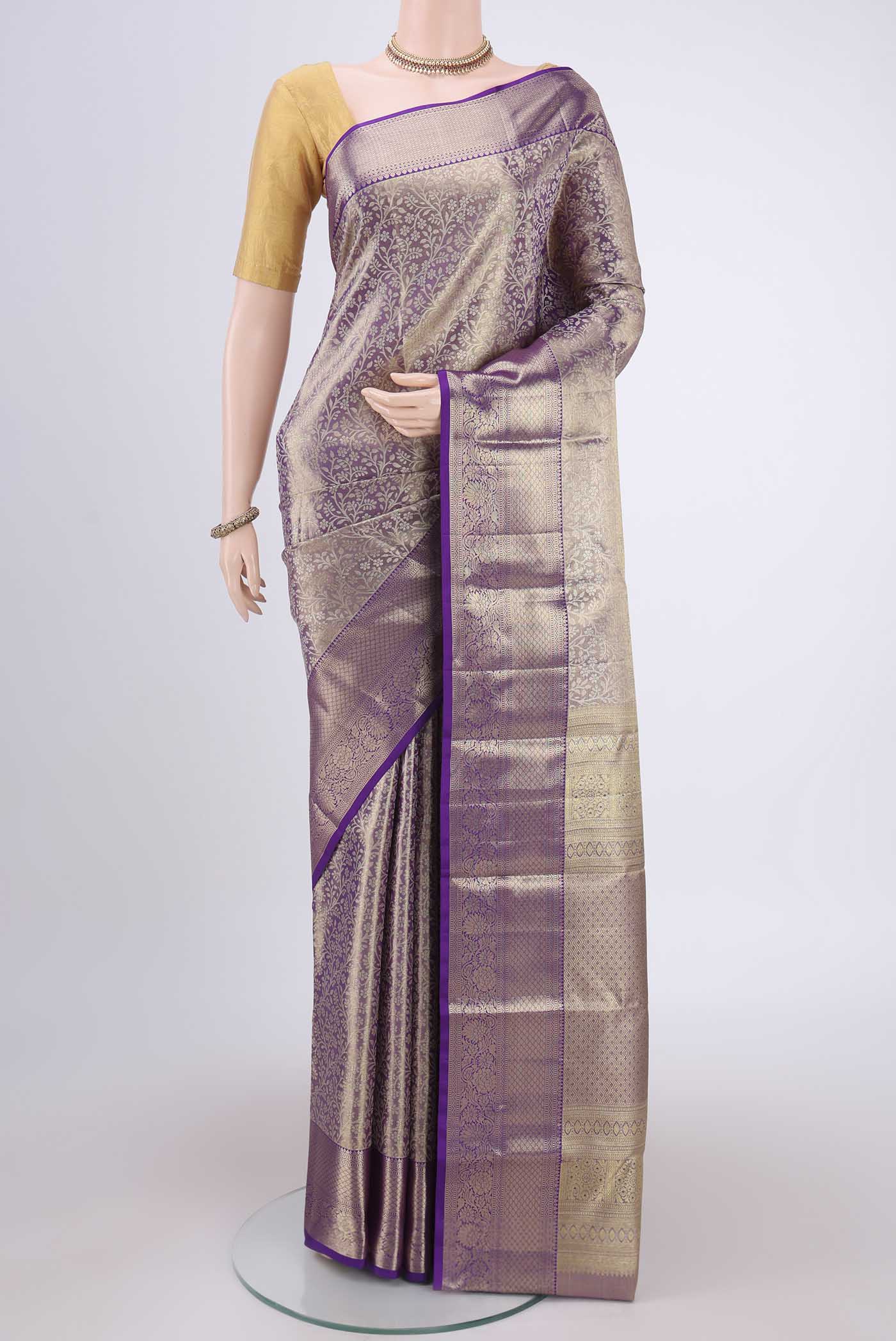 Purple Kanjivaram Silk Saree with Zari Brocade on the body and Zari Border.  displayed on a mannequin