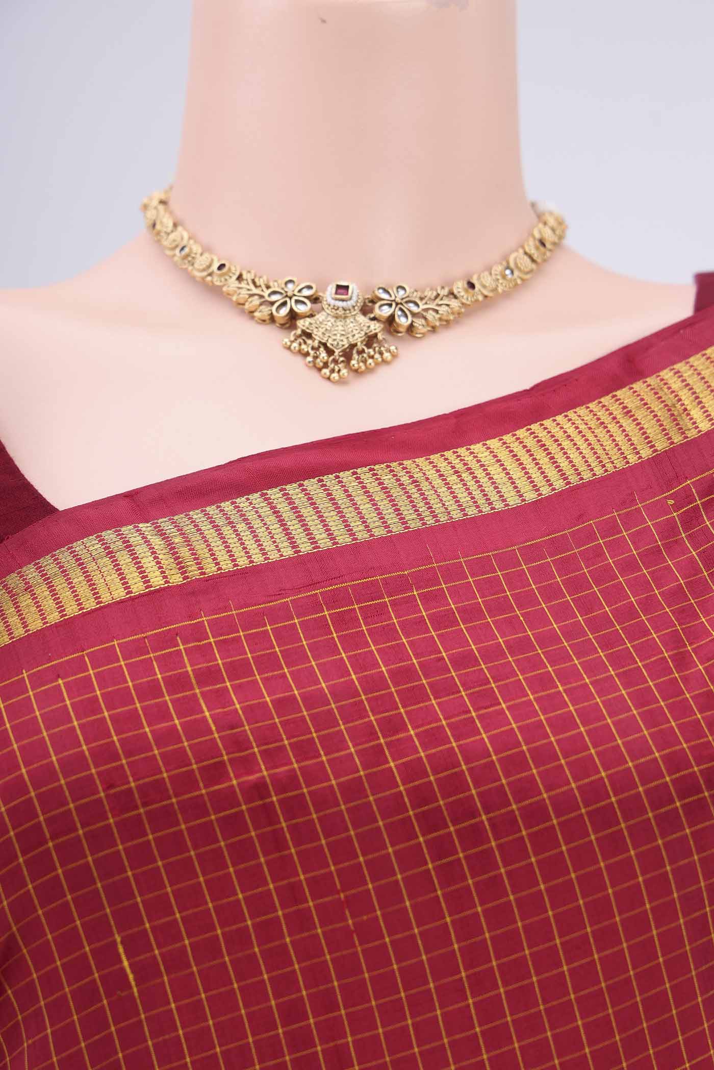 Border image of Maroon Dual Tone Kanchipuram Silk Saree with Checked design on the body and Zari Border. 