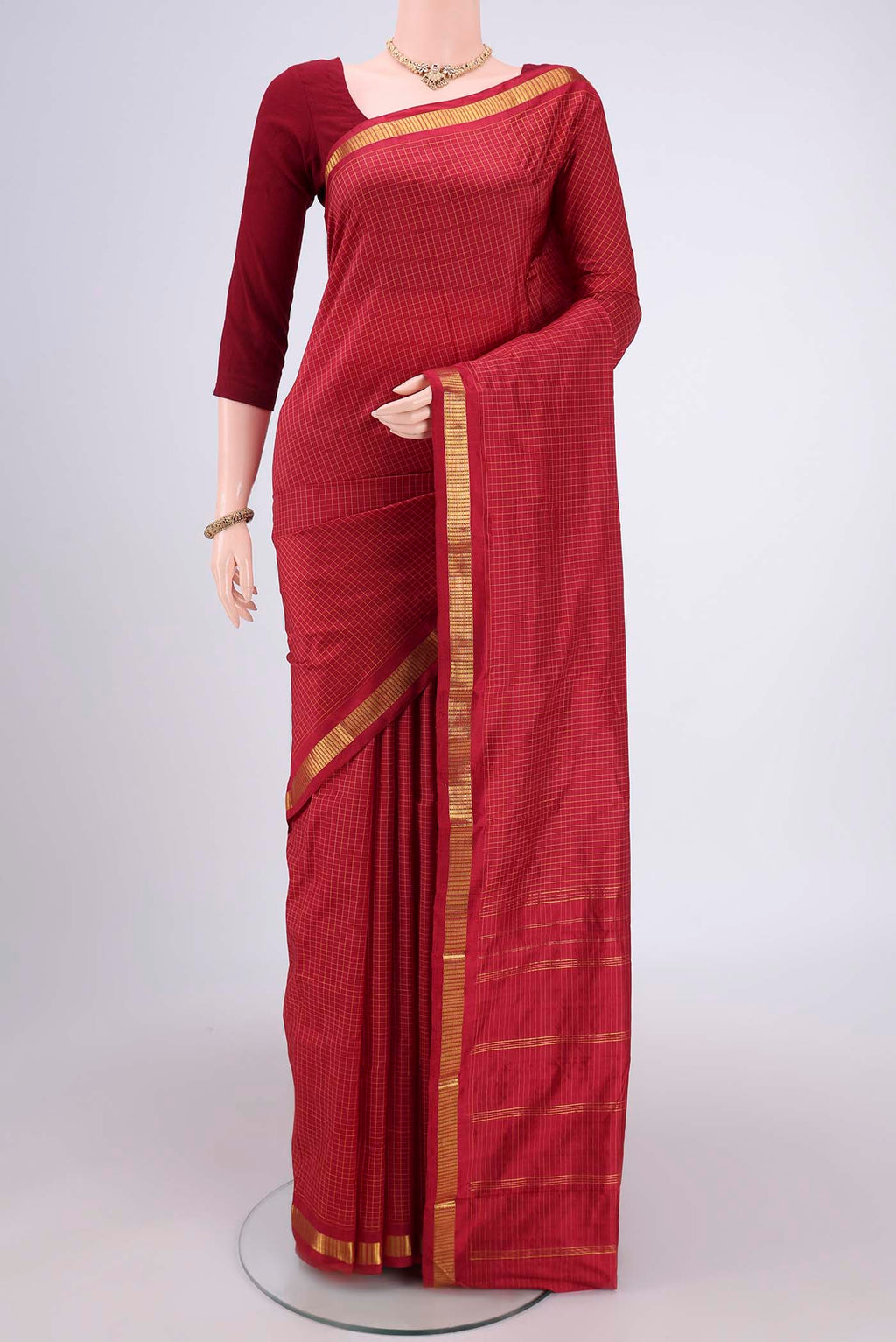 Maroon Dual Tone Kanchipuram Silk Saree with Checked design on the body and Zari Border.  displayed on a mannequin