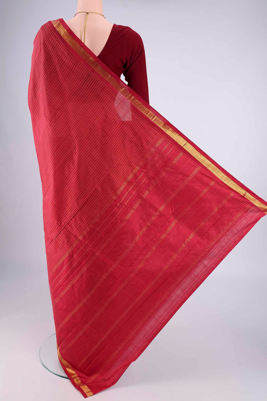 Flat view of Maroon Kanchipuram Silk Saree with Checked design on the body and Zari Border. 