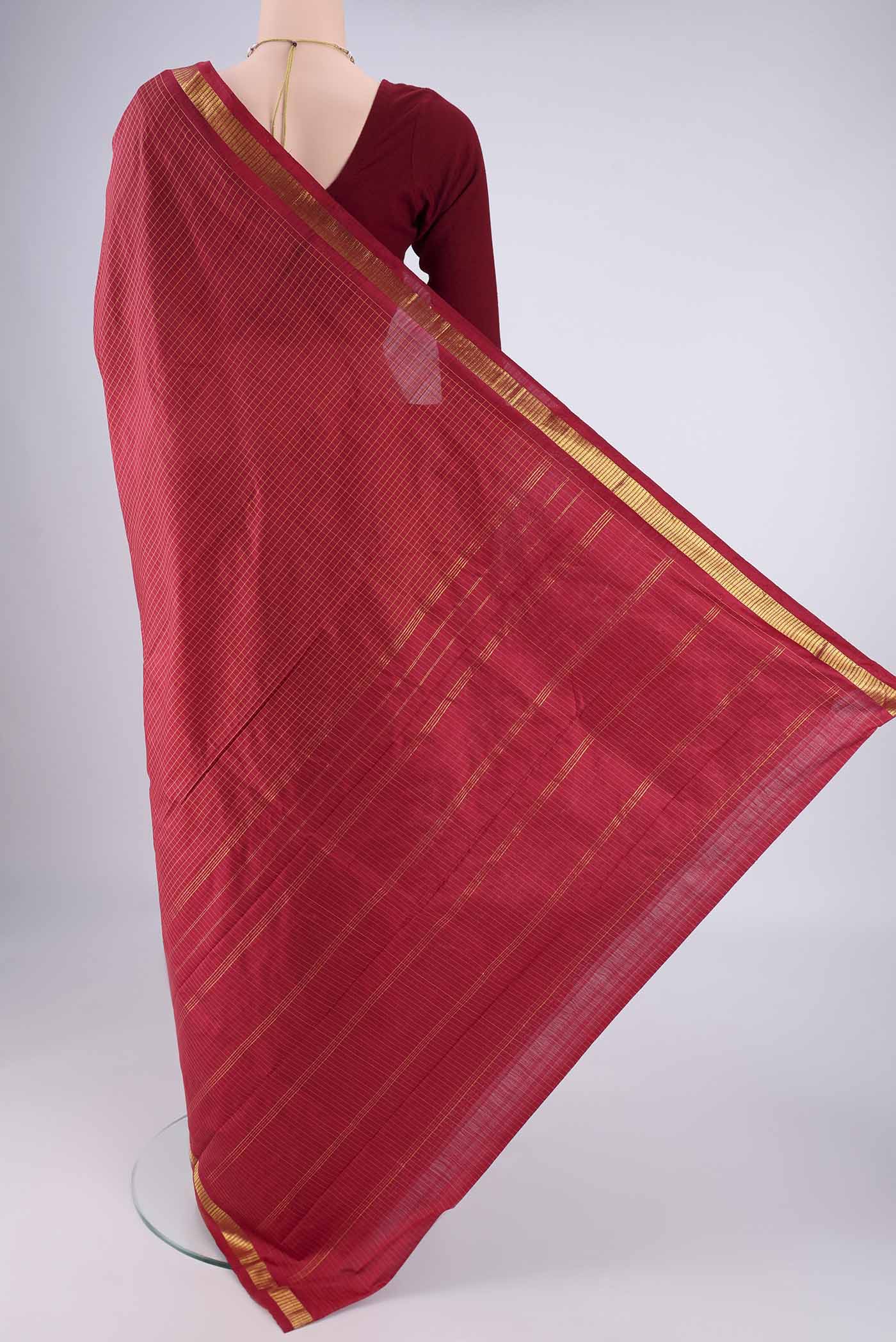 Flat view of Maroon Kanchipuram Silk Saree with Checked design on the body and Zari Border. 