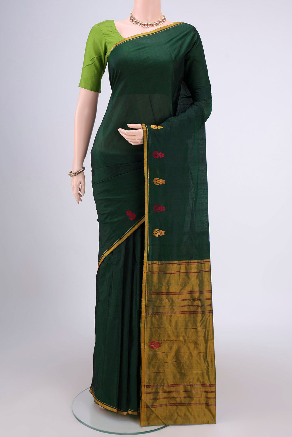 Bottle Green Dual Tone Kanchipuram Silk Saree with Plain Body and Zari And Thread Border.  displayed on a mannequin