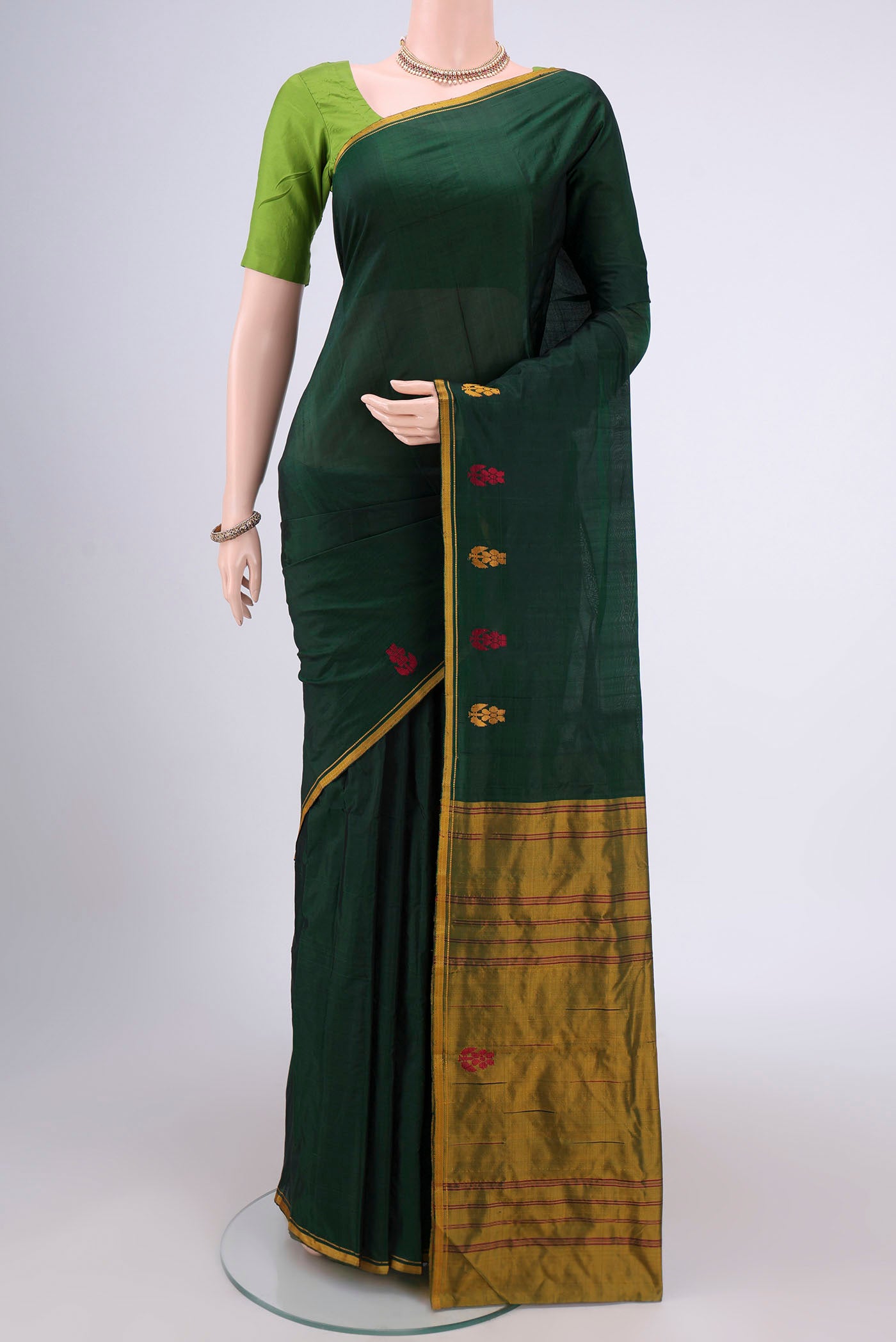 Bottle Green Dual Tone Kanchipuram Silk Saree with Plain Body and Zari And Thread Border.  displayed on a mannequin