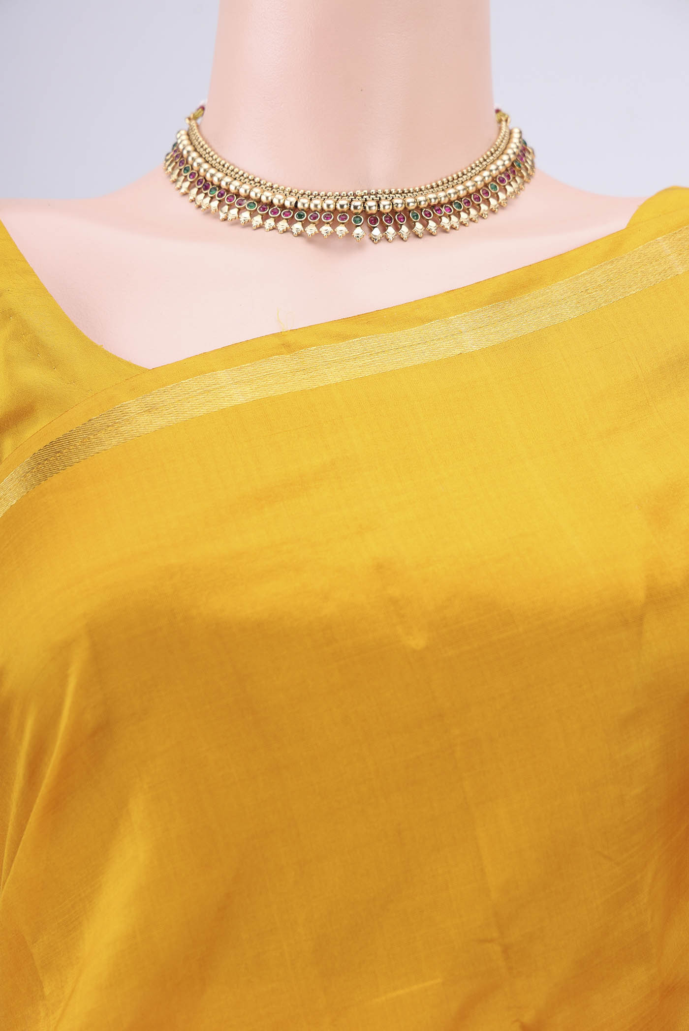Border image of Mustard Kanchipuram Silk Saree with Plain Body and Zari And Thread Border. 