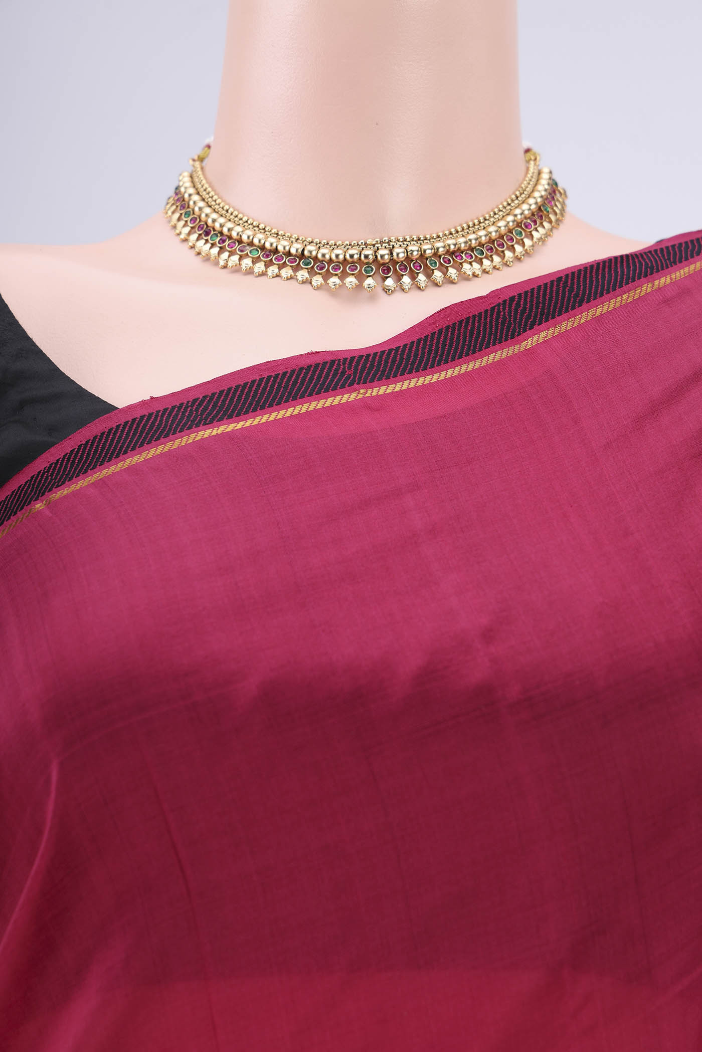 Border image of Maroon Kanchipuram Silk Saree with Plain Body and Zari And Thread Border. 
