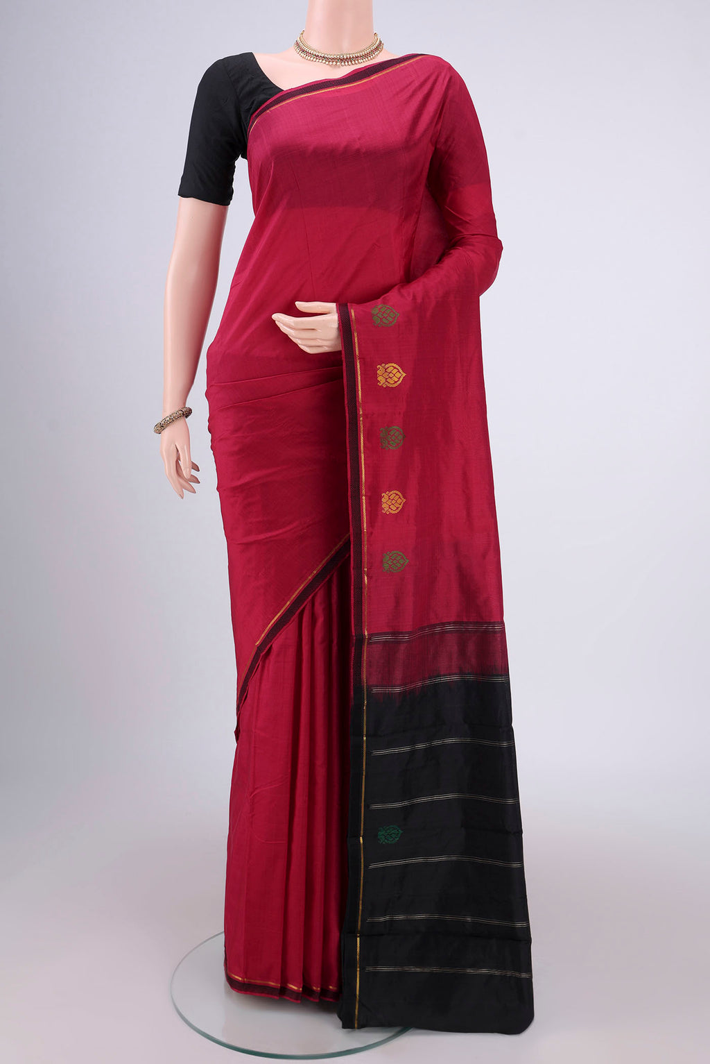 Maroon Kanchipuram Silk Saree with Plain Body and Zari And Thread Border.  displayed on a mannequin