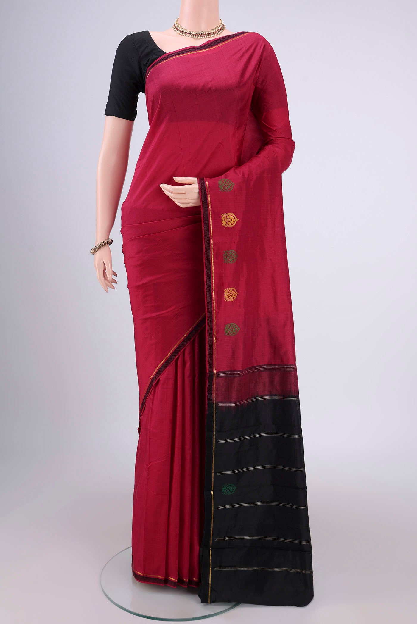 Maroon Kanchipuram Silk Saree with Plain Body and Zari And Thread Border.  displayed on a mannequin