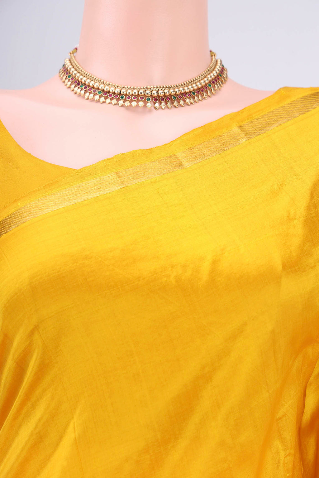 Border image of Yellow Kanchipuram Silk Saree with Plain Body and Zari And Thread Border. 