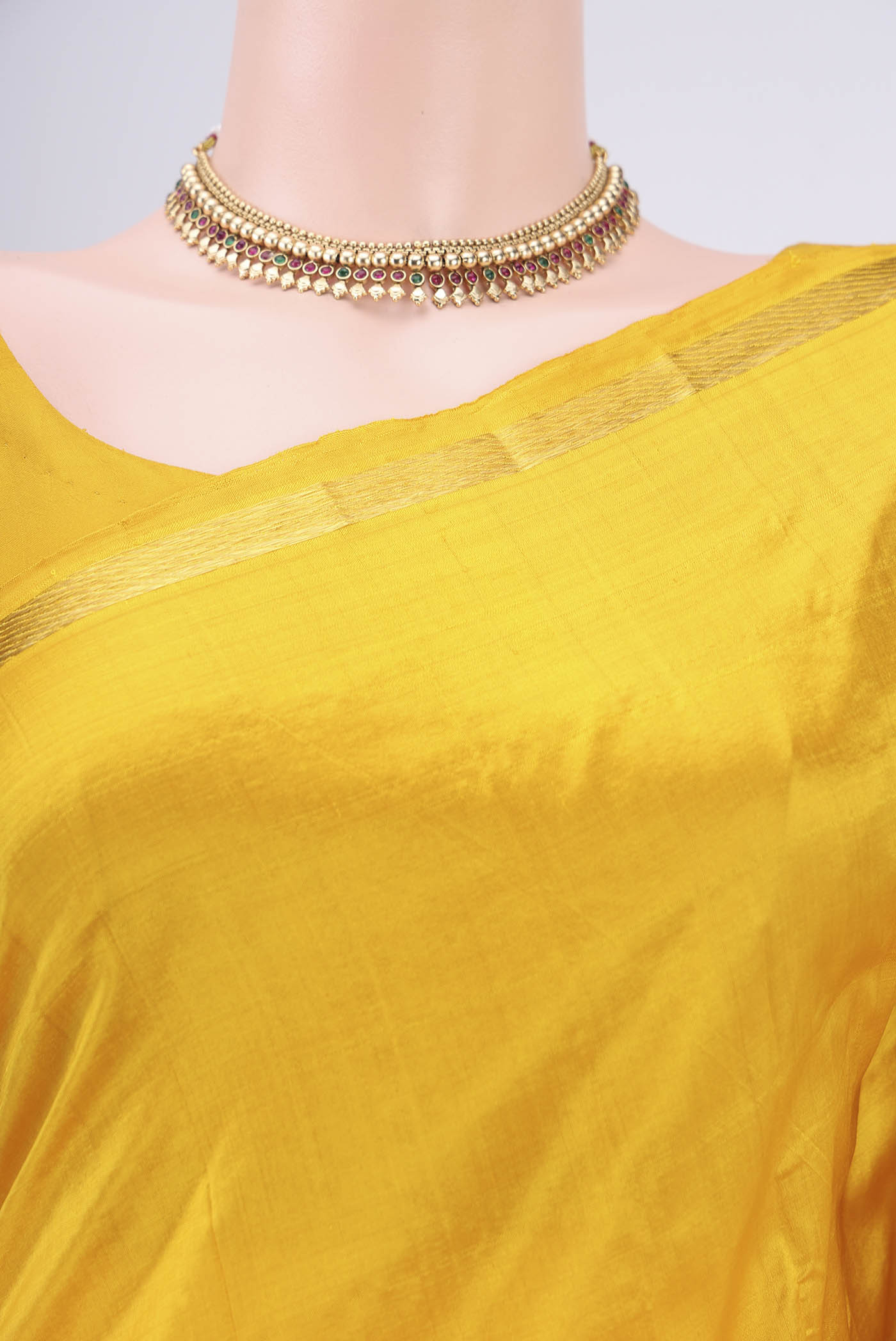 Border image of Yellow Kanchipuram Silk Saree with Plain Body and Zari And Thread Border. 
