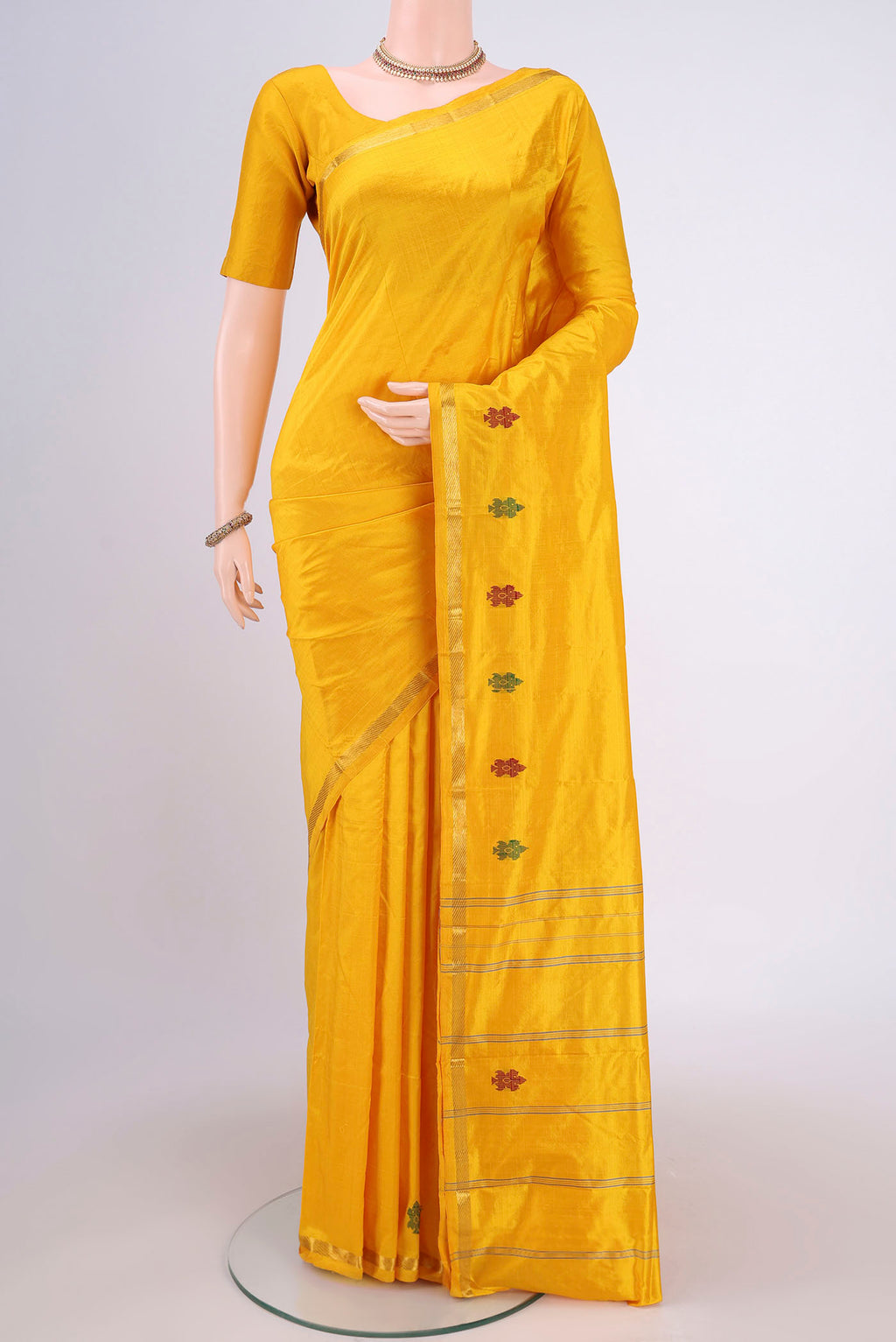 Yellow Kanchipuram Silk Saree with Plain Body and Zari And Thread Border.  displayed on a mannequin