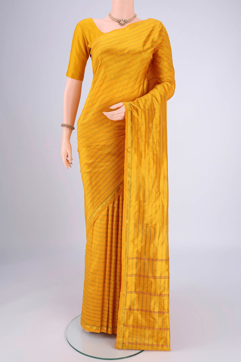 Mustard Dual Tone Kanchipuram Silk Saree with Stripes on the body and Zari Border.  displayed on a mannequin