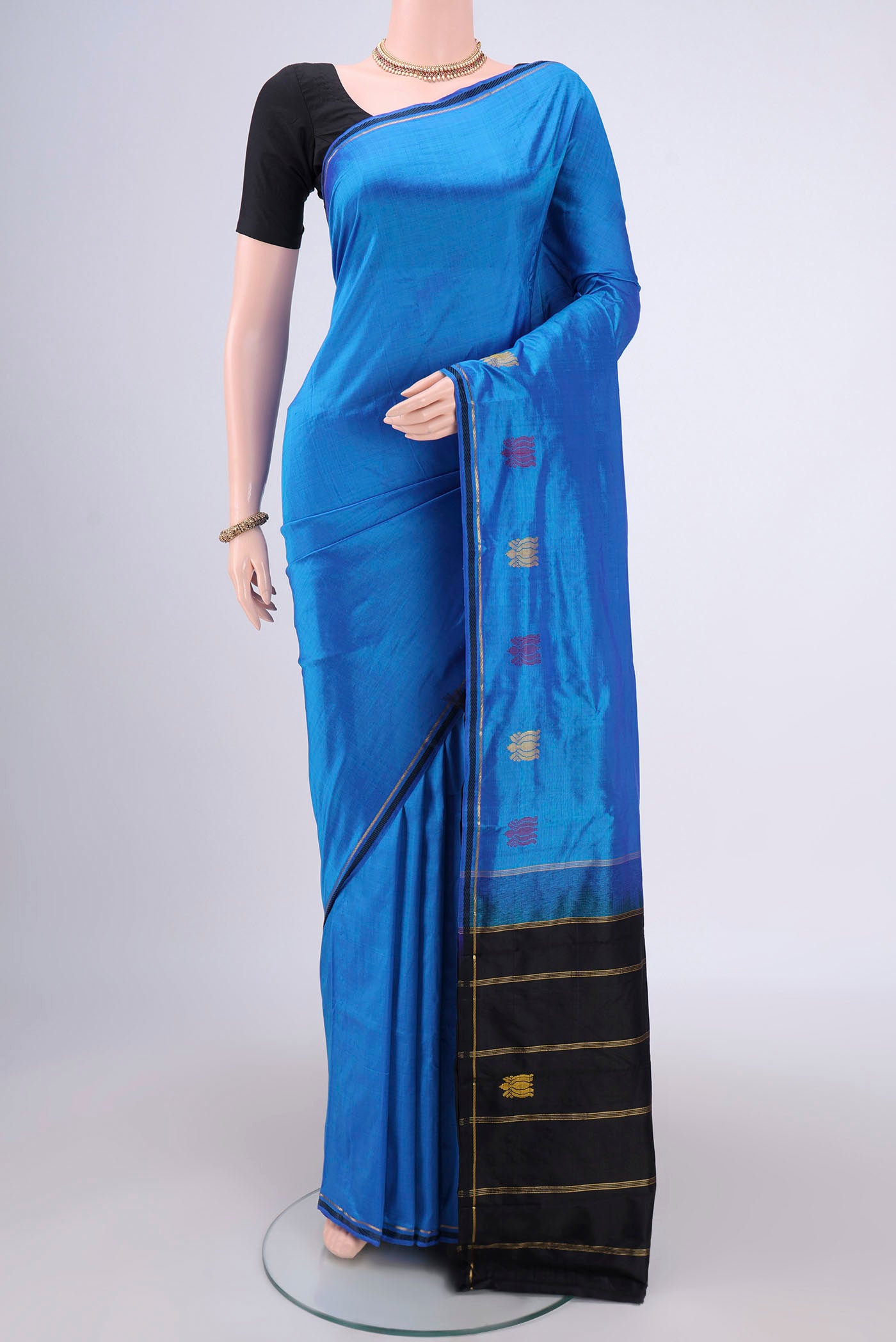 Blue Kanchipuram Silk Saree with Plain Body and Zari Border.  displayed on a mannequin