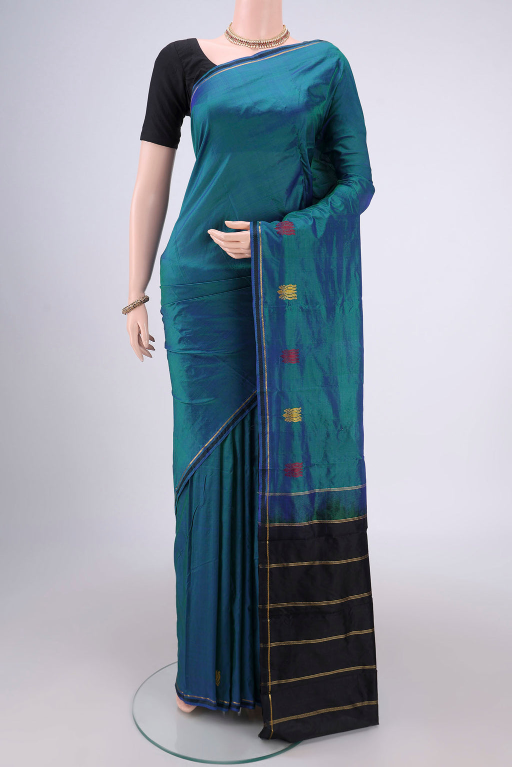 Peacock Blue Kanchipuram Silk Saree with Plain Body and Zari And Thread Border.  displayed on a mannequin
