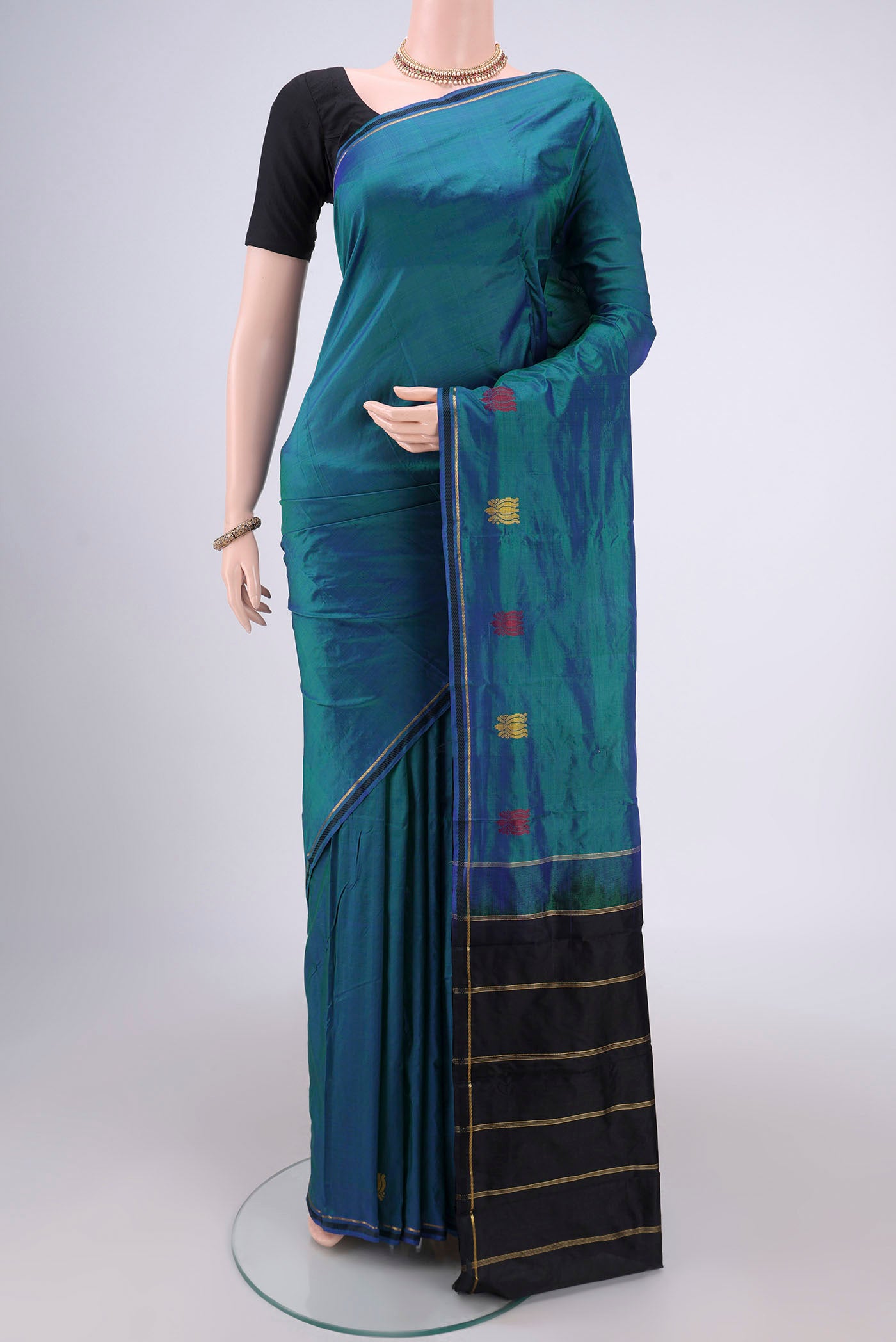 Peacock Blue Kanchipuram Silk Saree with Plain Body and Zari And Thread Border.  displayed on a mannequin