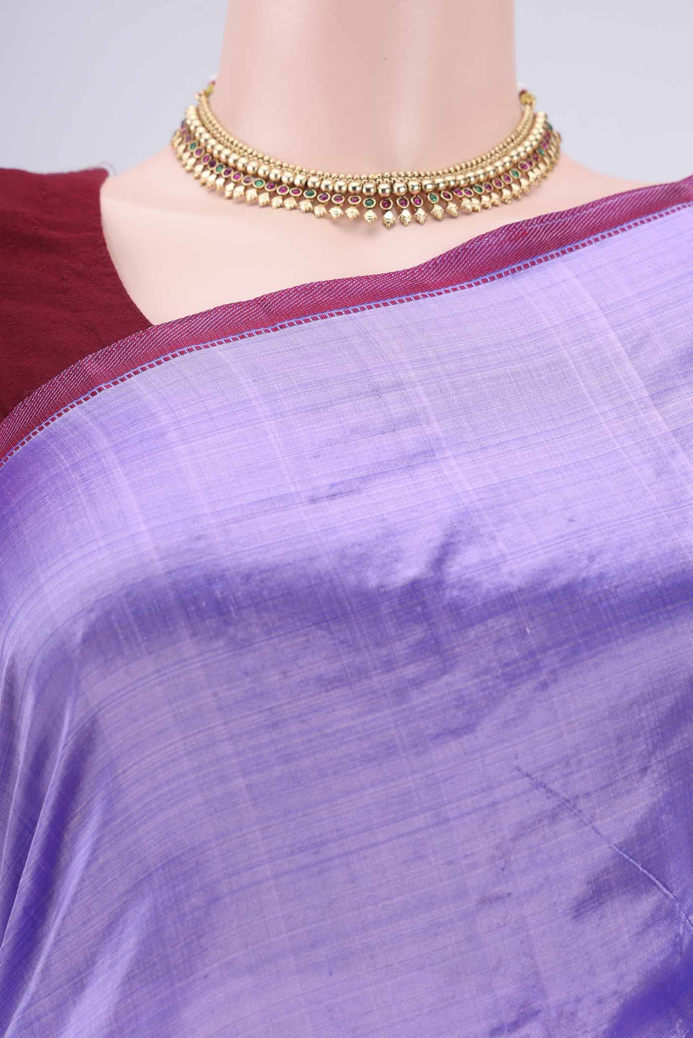 Border image of Violet Kanchipuram Silk Saree with Plain Body and Zari And Thread Border. 