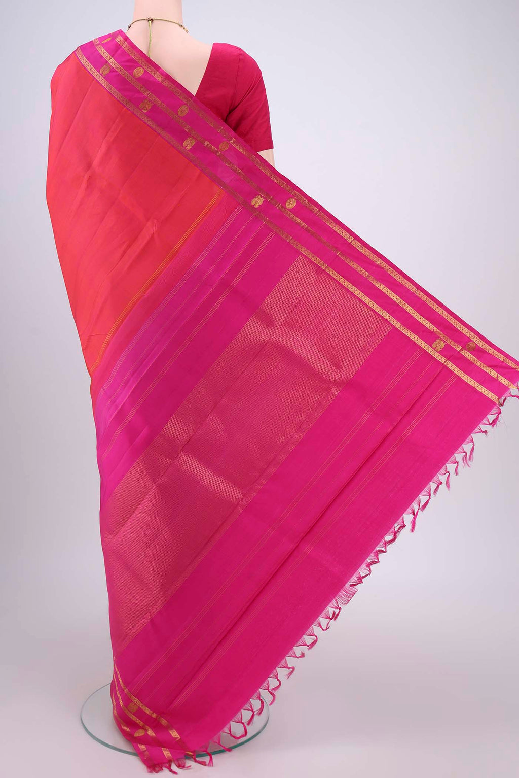 Flat view of Orange Dual Tone Kanchipuram Silk Saree with Plain Body and Attached Border. 