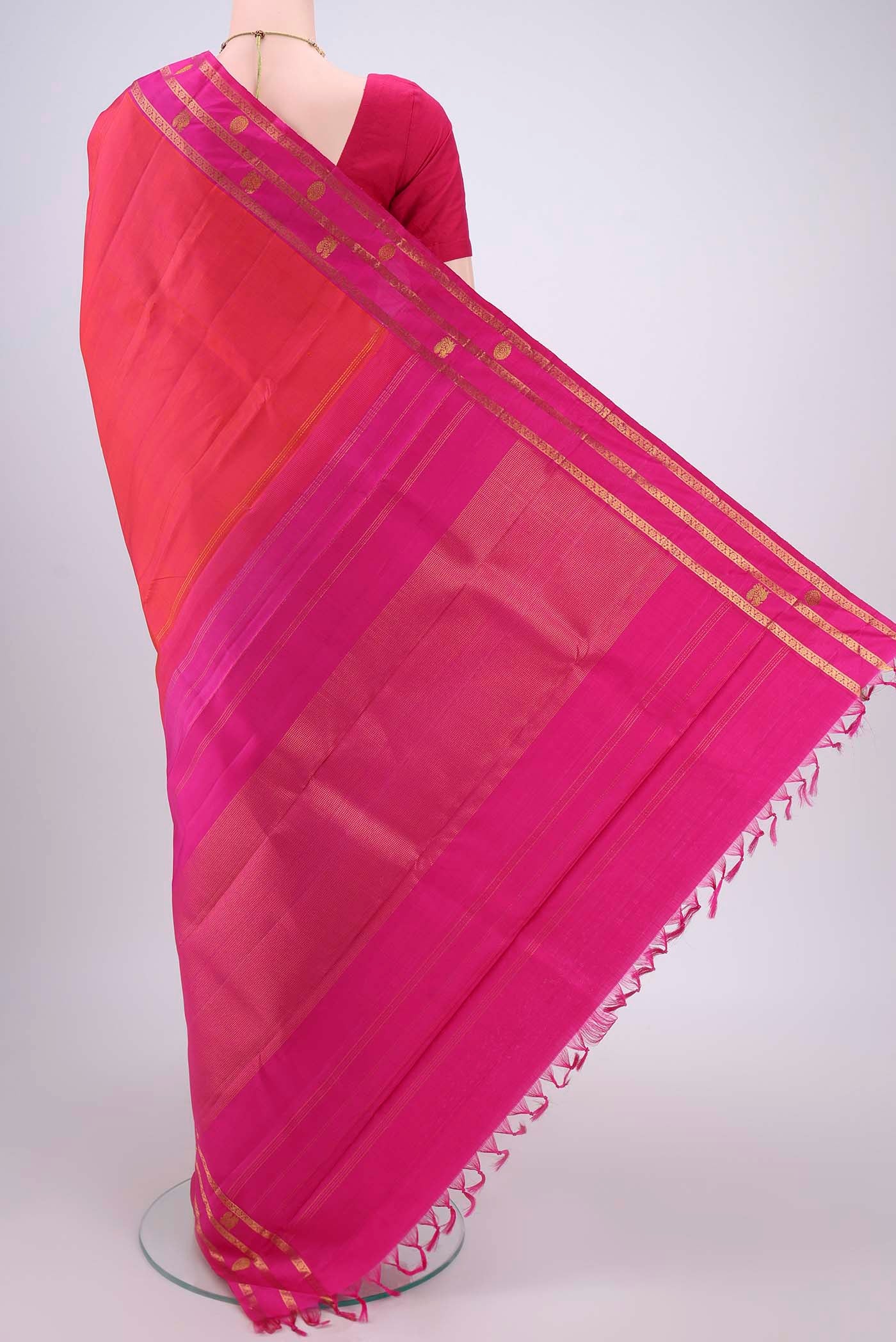 Flat view of Orange Dual Tone Kanchipuram Silk Saree with Plain Body and Attached Border. 