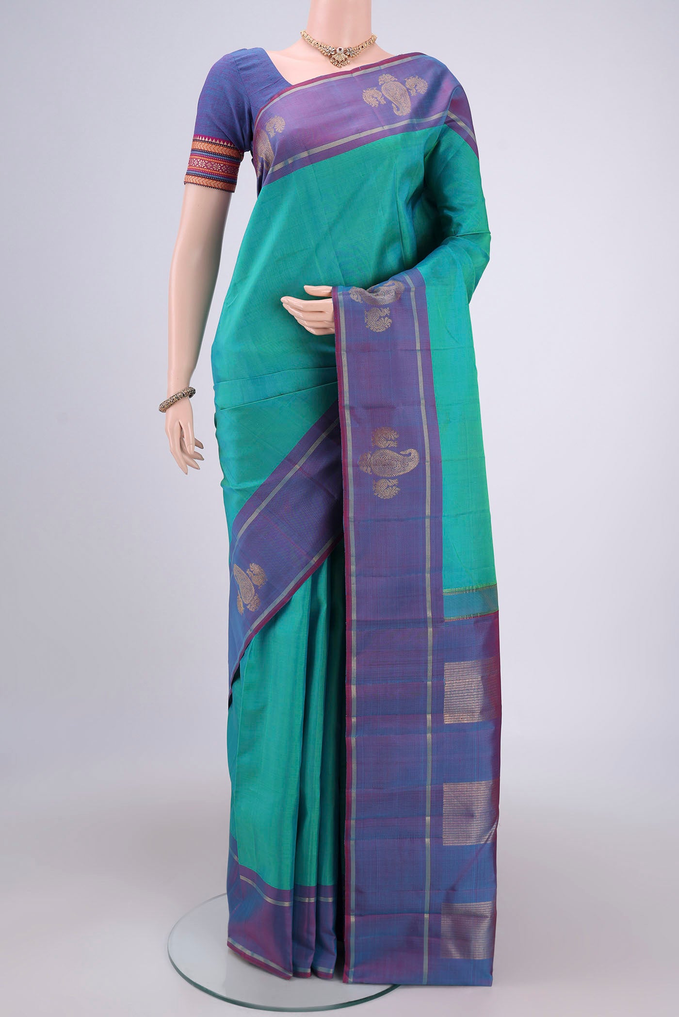 Turquoise Dual Tone Kanchipuram Silk Saree with Plain Body and Attached Border.  displayed on a mannequin